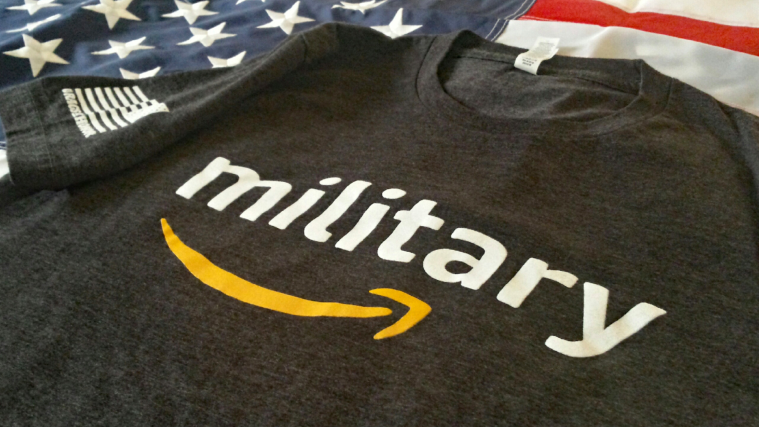 An image of a shirt with that shows the word "military" above the Amazon logo.