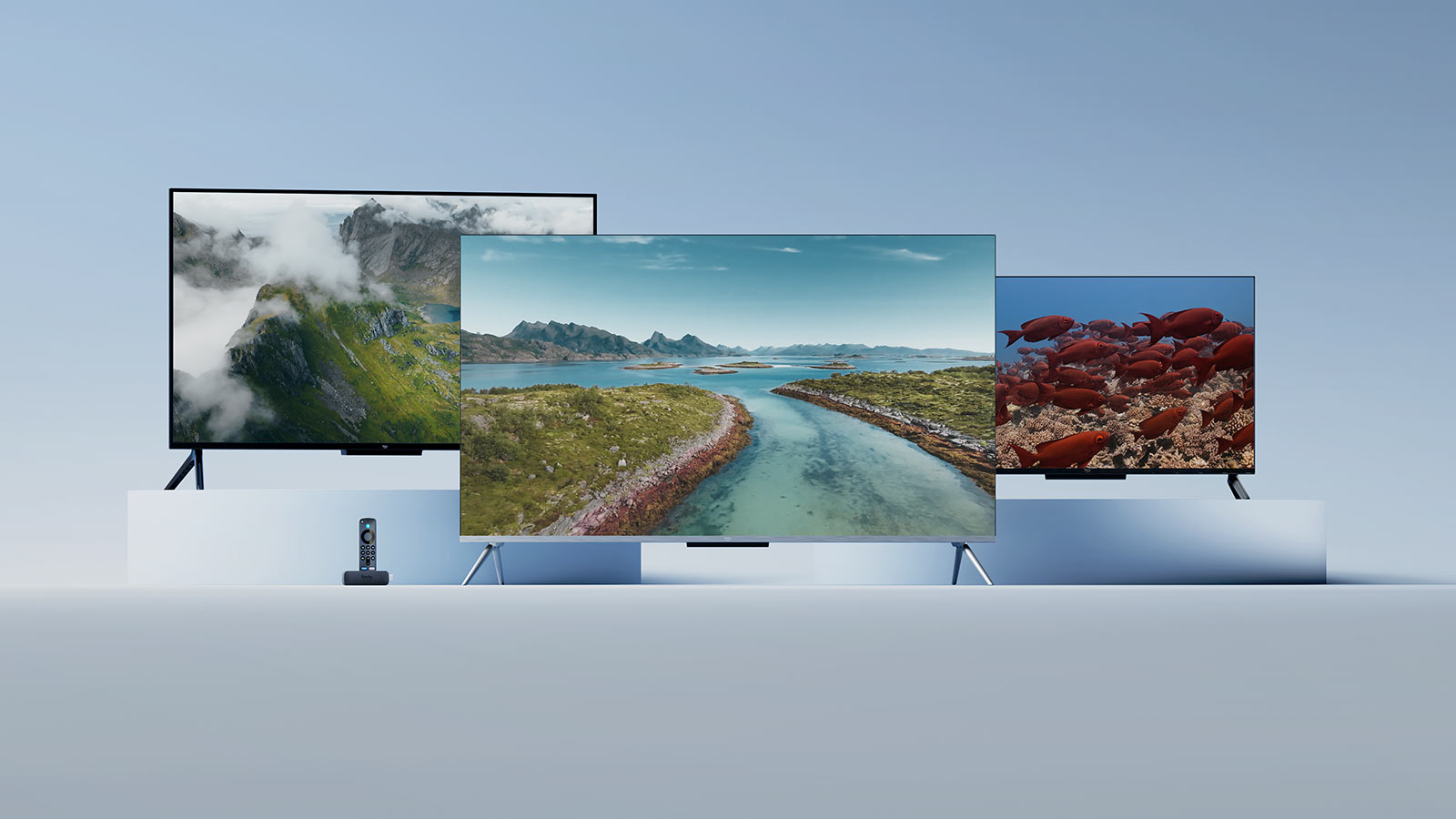 Three TV screens displaying nature scenes: misty mountains, winding river, and red fish