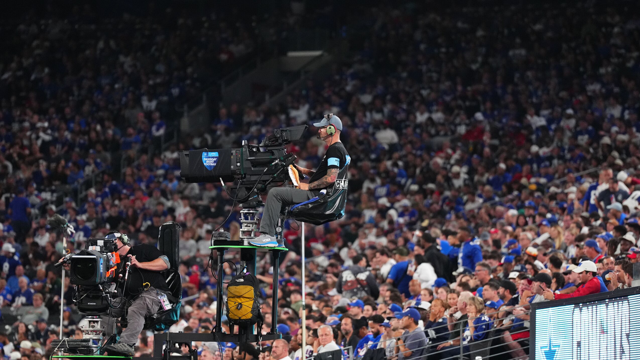 Camera operators high above crowd during 'Thursday Night Football' game