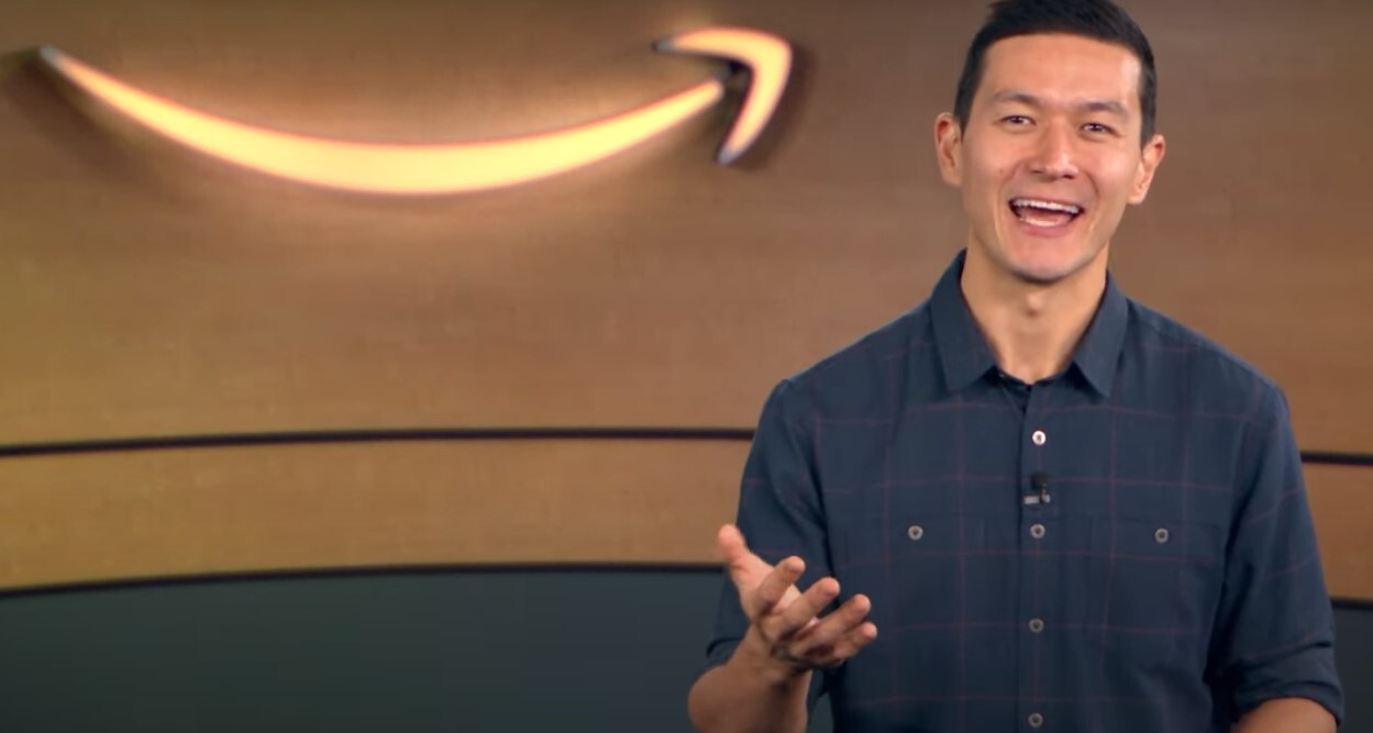 An Amazon senior manager talks about interview tips with an Amazon logo behind him.