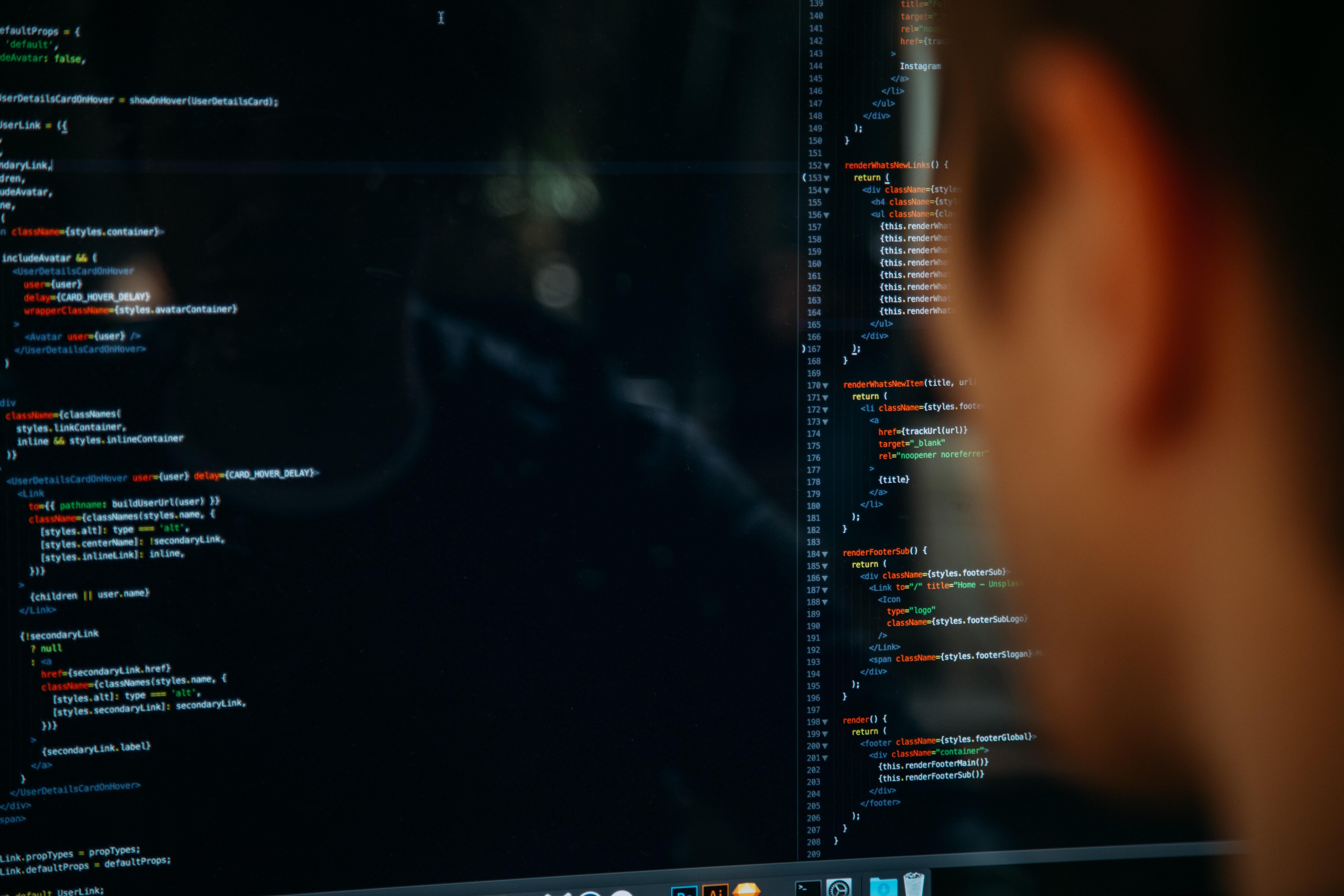 A student looking at the computer screen which shows coding