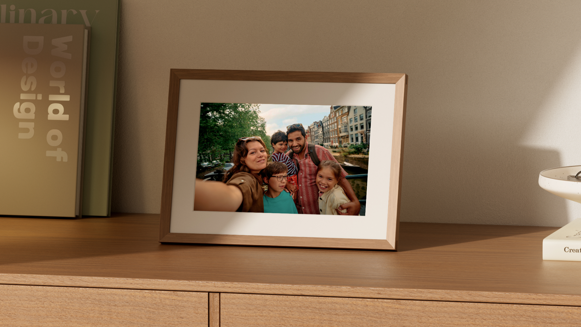 A photo of a family within an Alexa Photo Frame, standing on a table.
