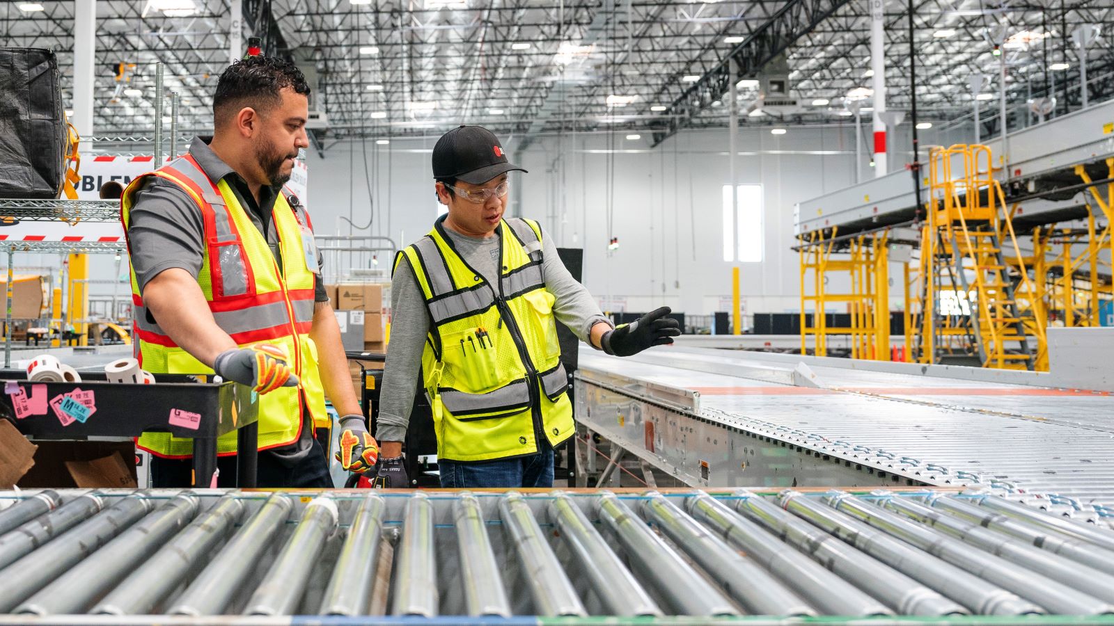 Safety-equipped personnel inspecting warehouse machinery