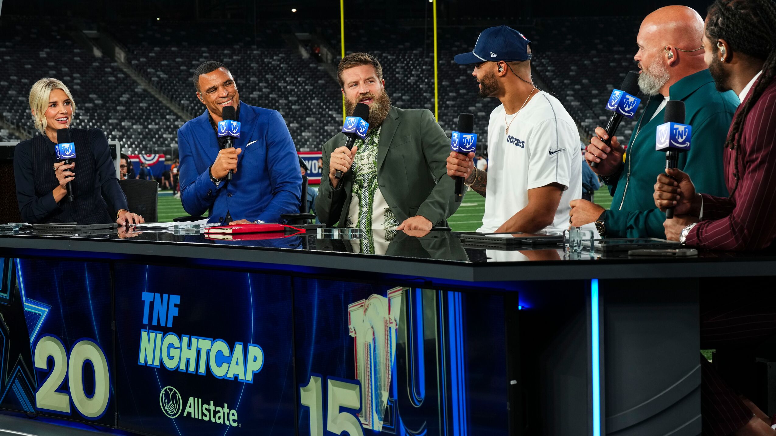 'Thursday Night Football' commentators at desk on football field