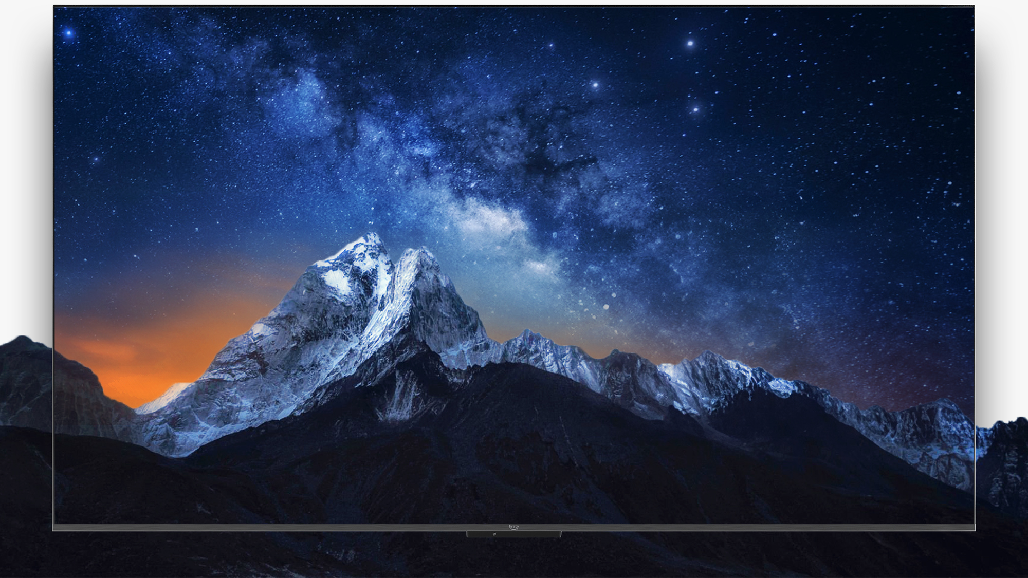 Fire TV Omni Series smart TV that is displaying a mountain range at nicht. 