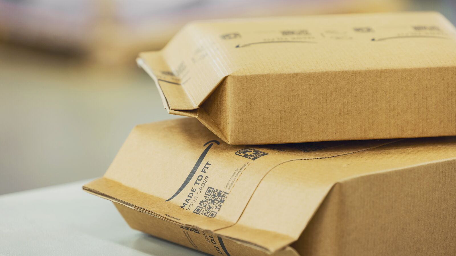 Stack of Amazon mailer envelopes with shipping labels and barcodes