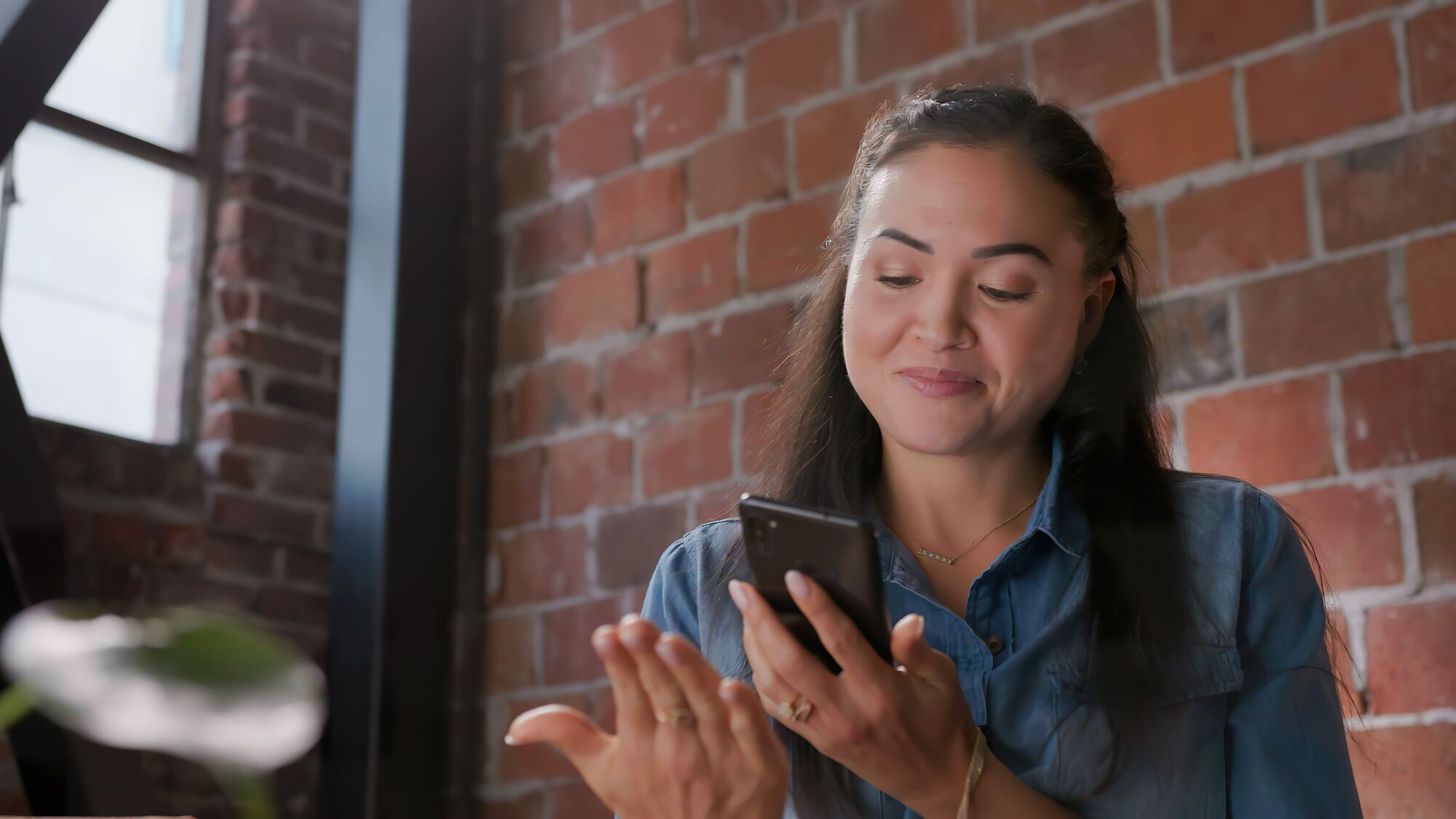 An image of a woman holding a phone and photographing her palm.