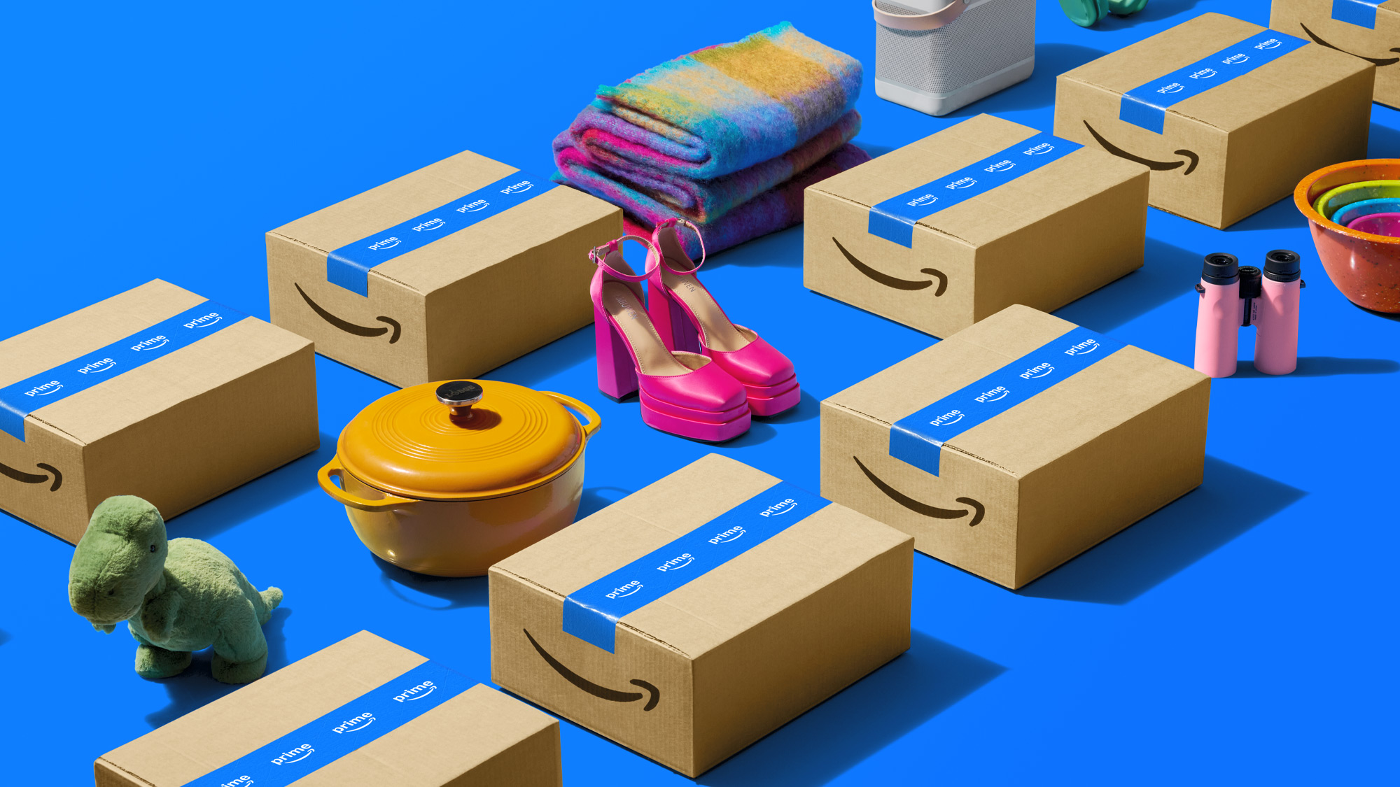 Amazon packages surrounded by colorful products on blue background.