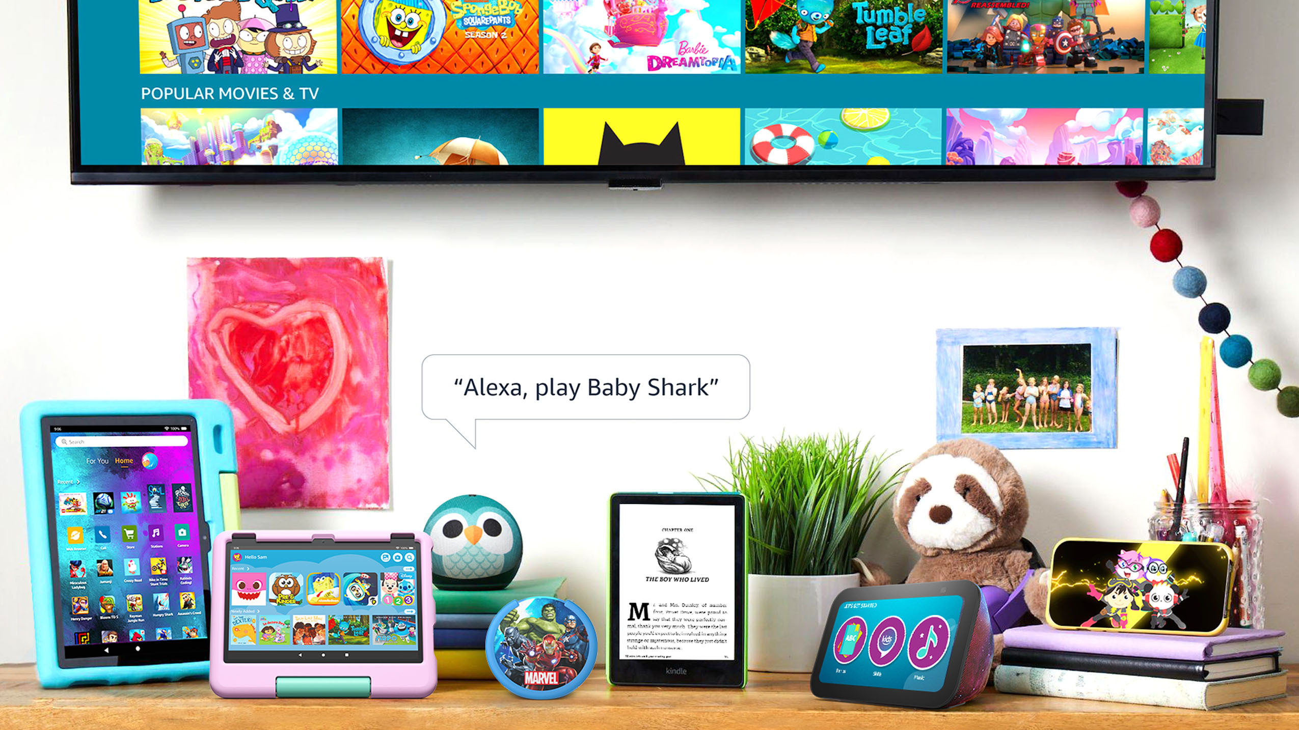 An image of all Amazon Kids devices displayed on a counter and a text box that reads "Alexa, play Baby Shark."