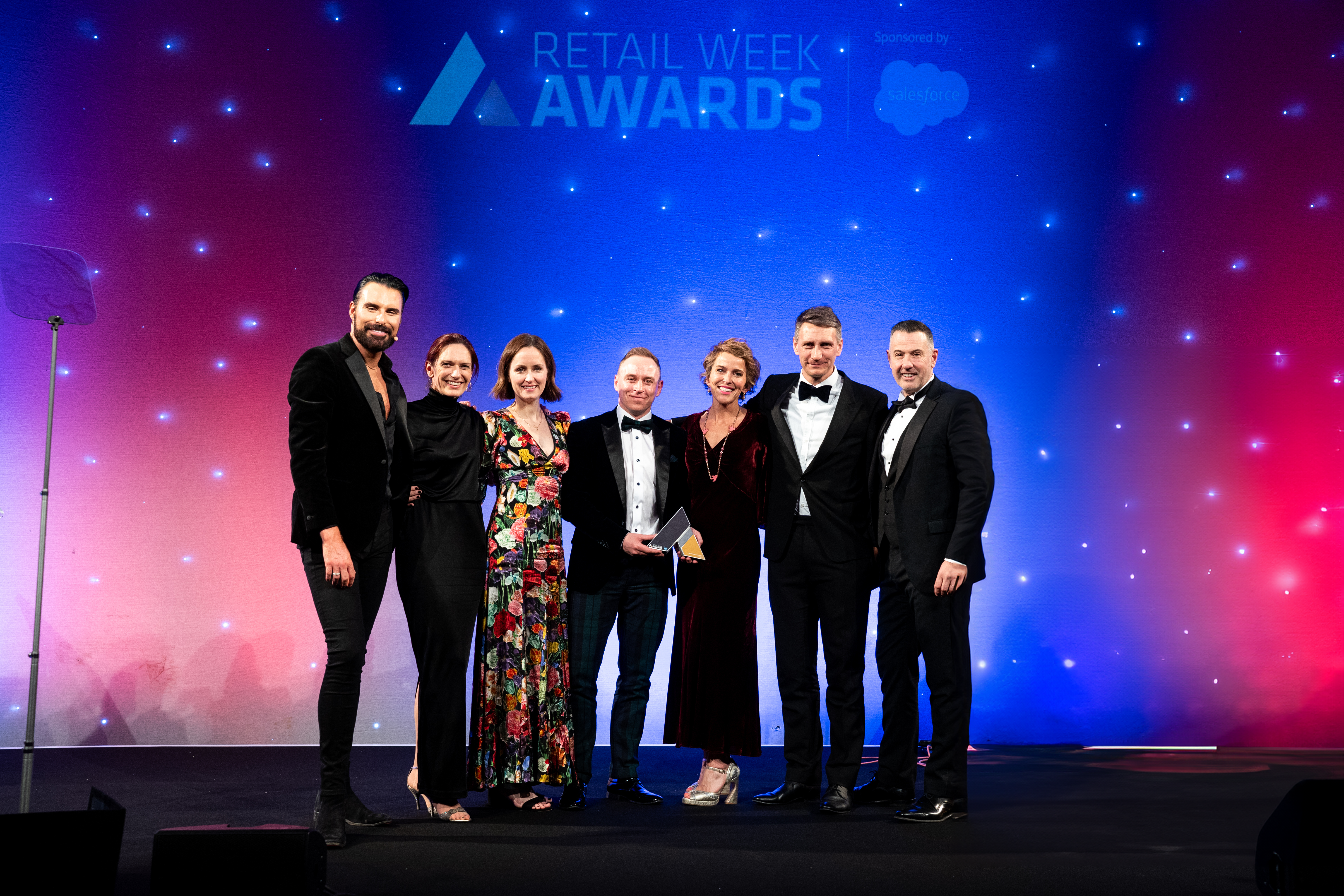 Amazon employees with host Rylan Clark collecting their awards at the Retail Week Awards 2024