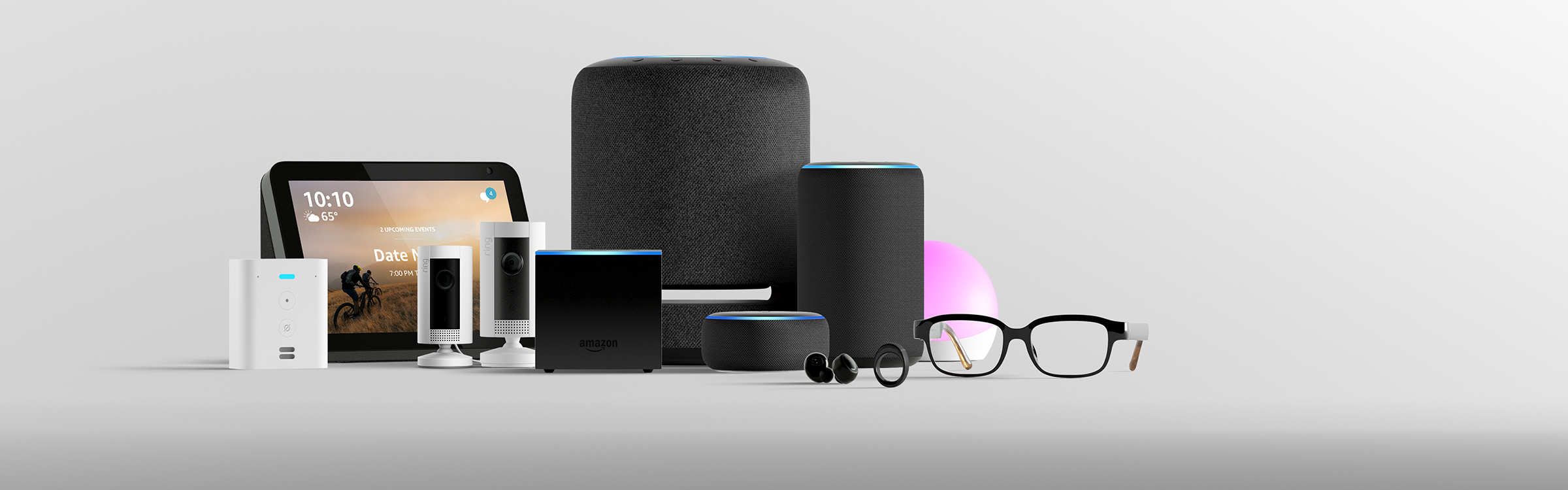 Amazon devices gathered together, in front of a gray background.