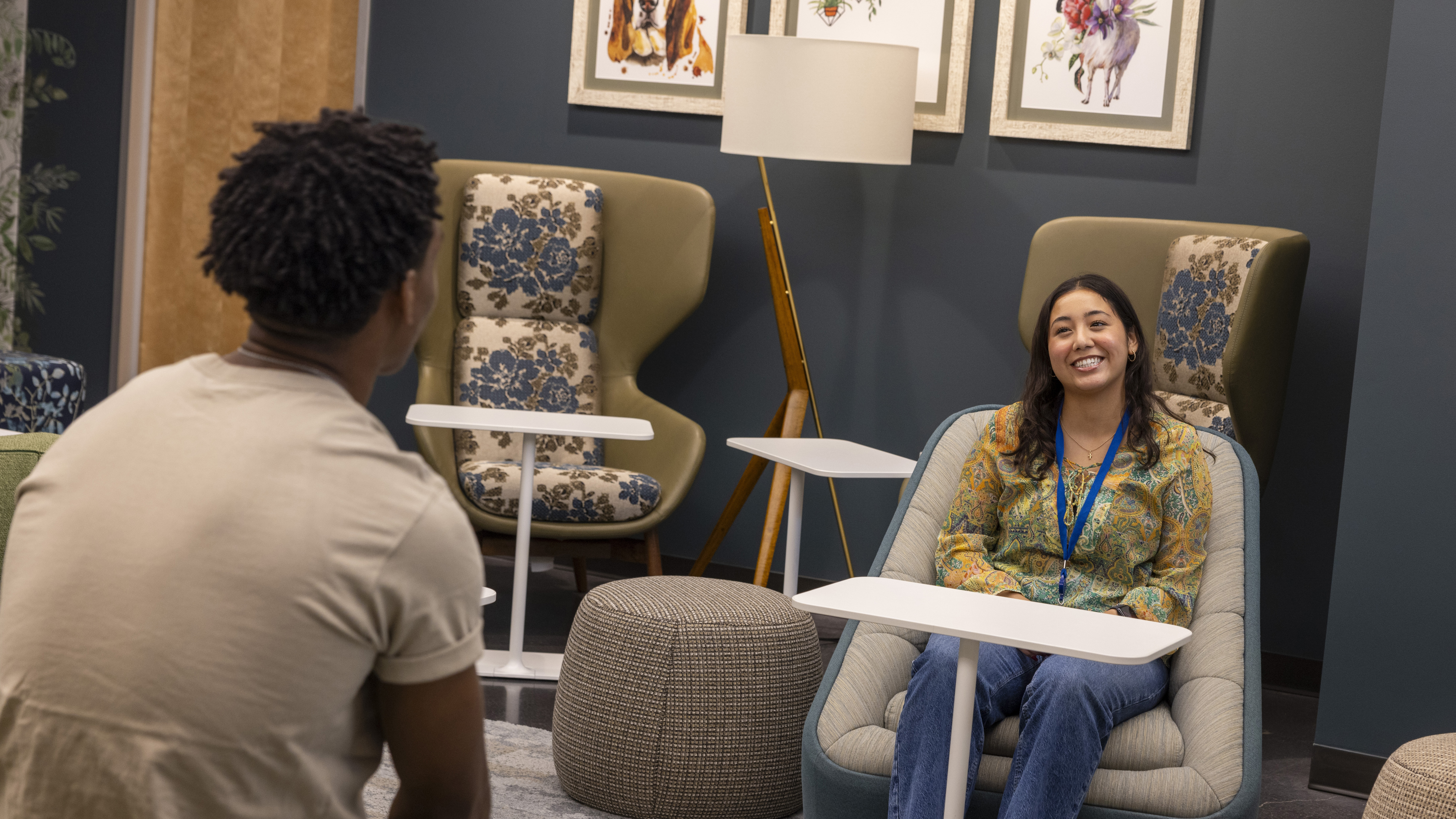 Two employees chat in a lounge inside of Day 1.