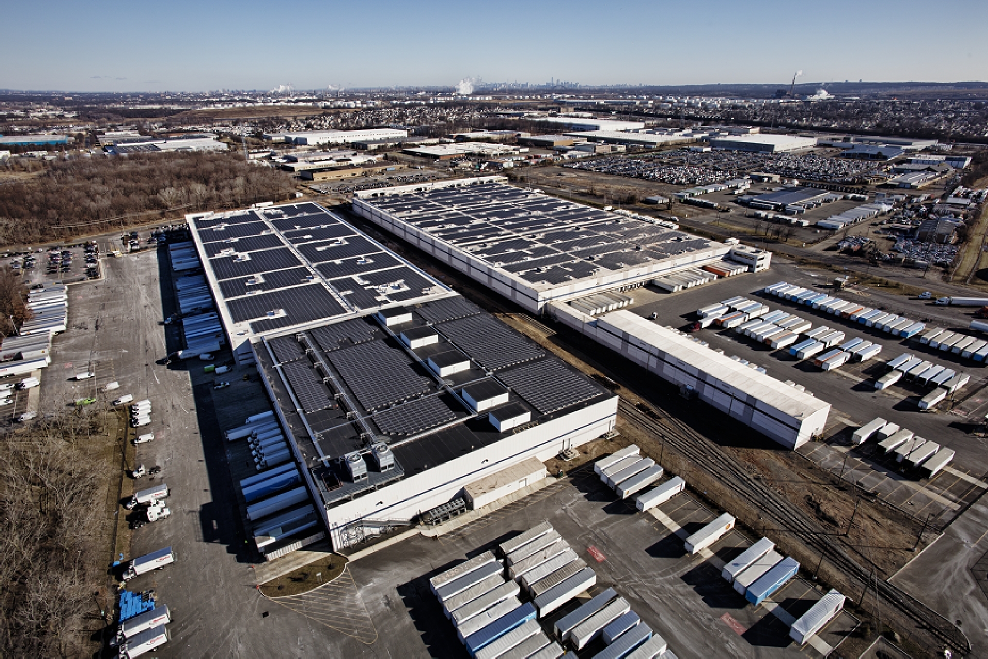Solar panels on top of a large building.