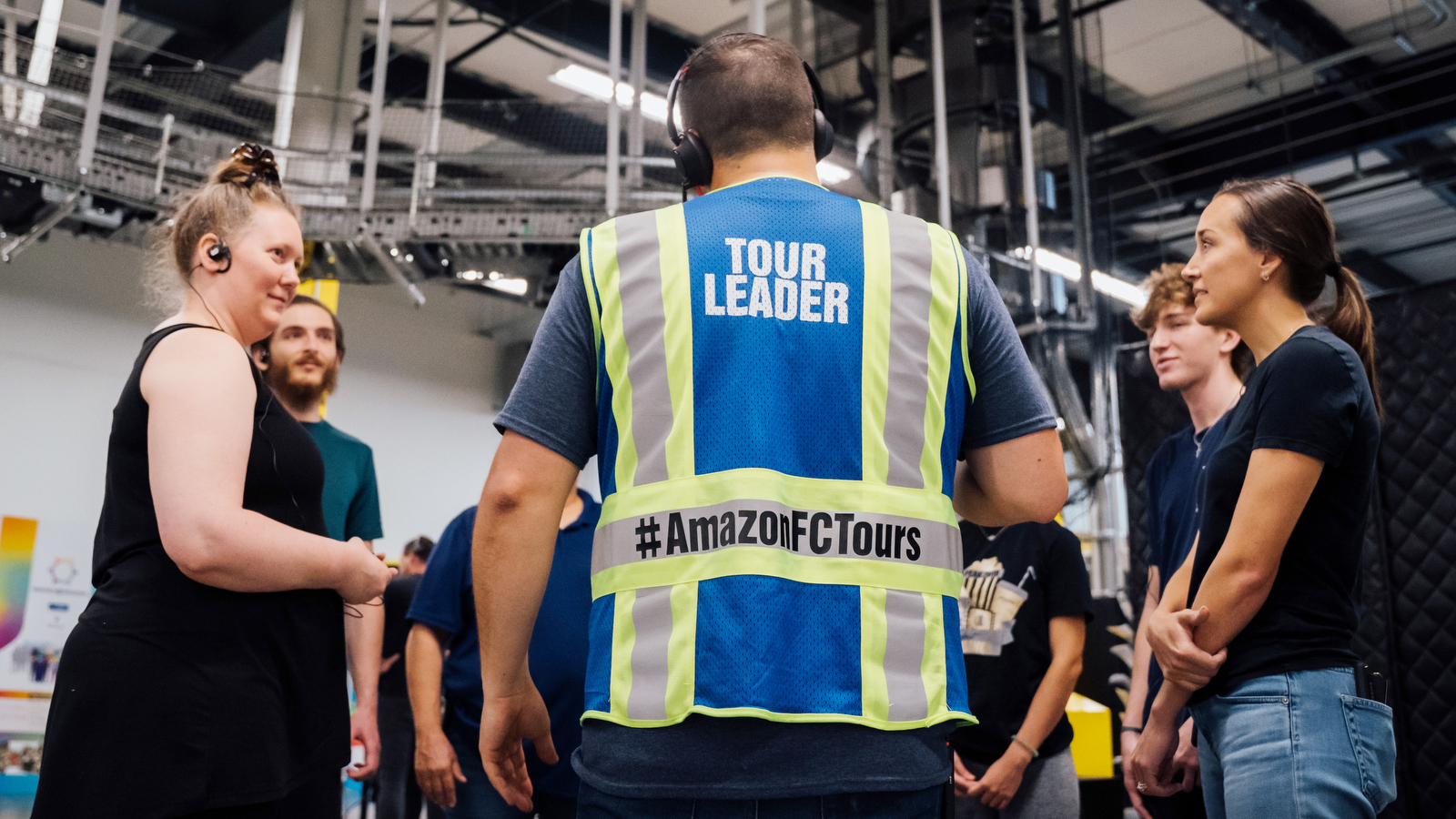 Amazon employees giving a tour of a fulfillment center.