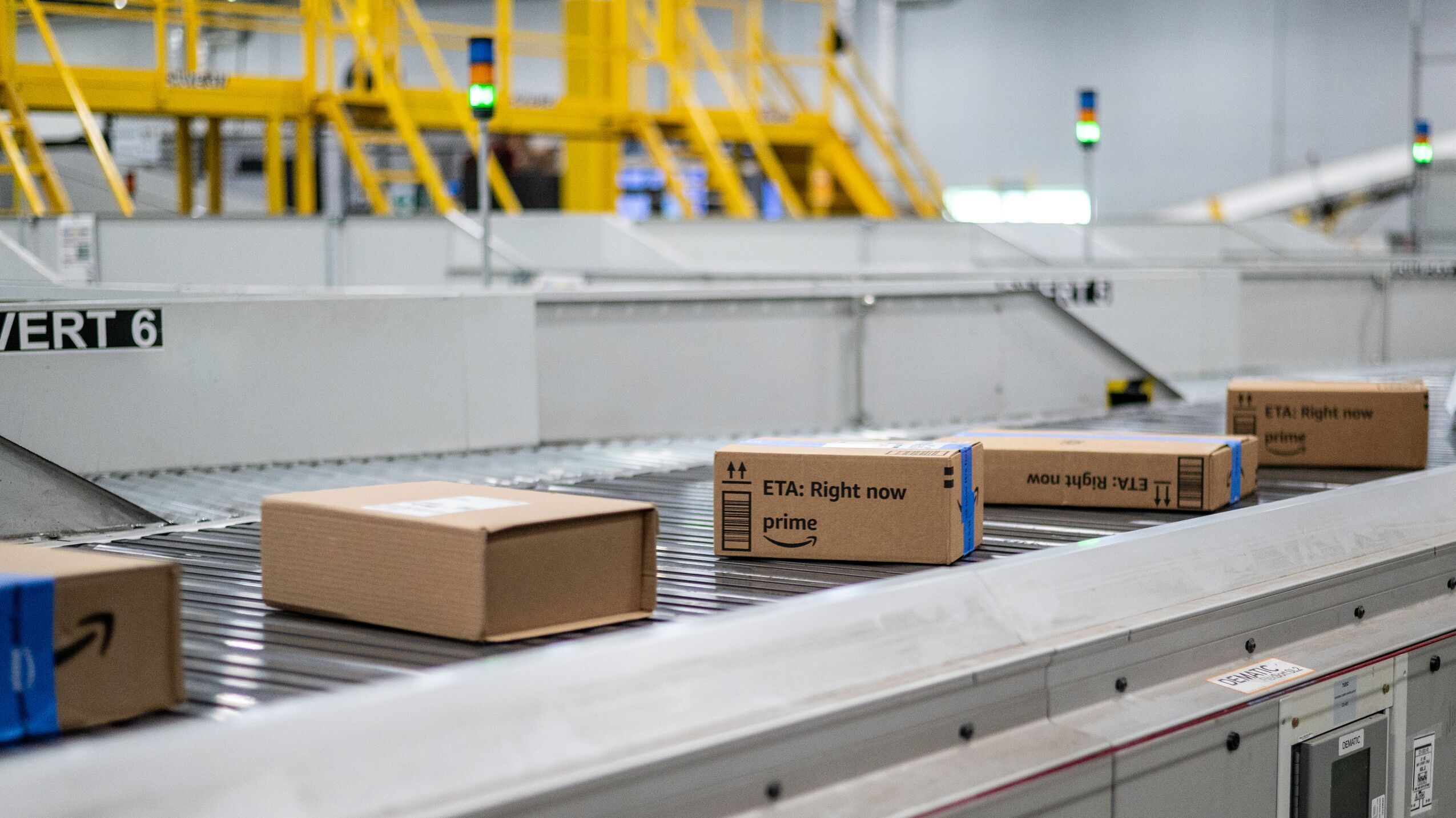 An image of Amazon boxes lined up on a conveyer belt. They are heading down the line to be processed in an Amazon Air facility.