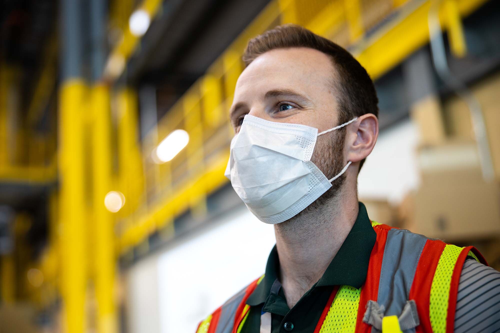 An associate in an Amazon fulfillment center with additional safety measures in response to the COVID-19 pandemic