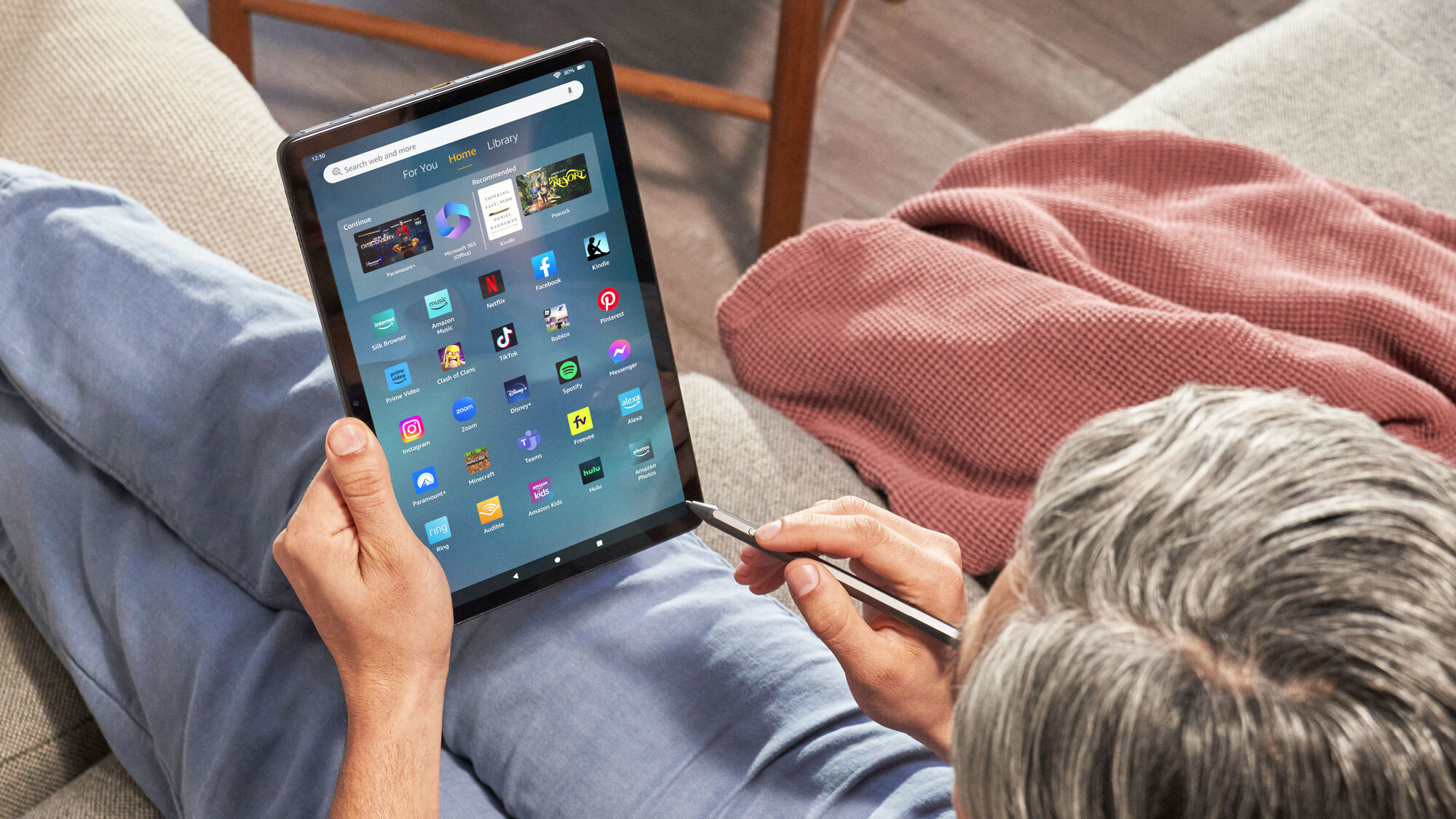 An image of a person using the Amazon's Fire Max 11 tablet.