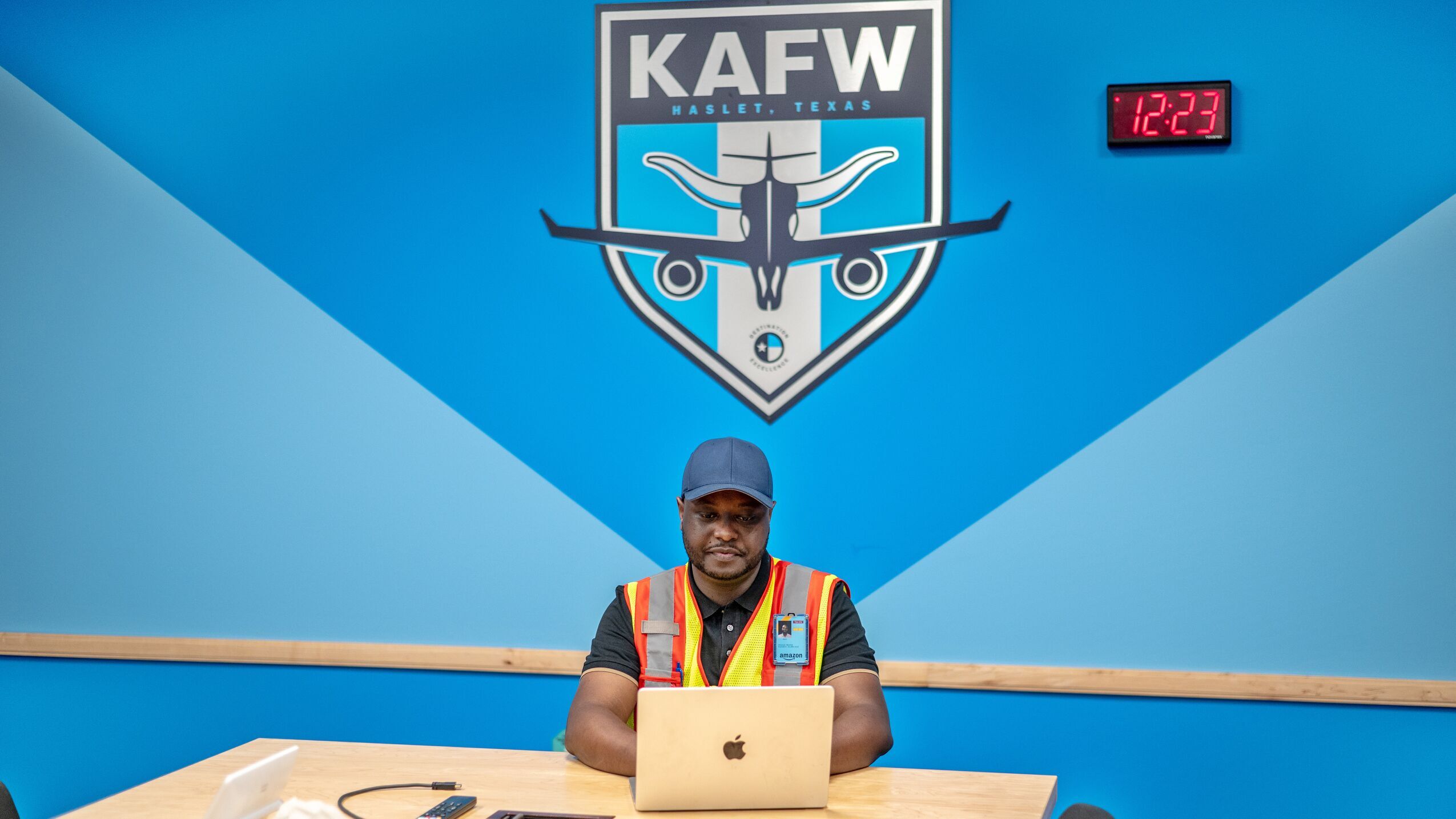 Marchel Sebacuzi working on a laptop in a conference room at the Amazon Air Hub in Dallas-Fort Worth