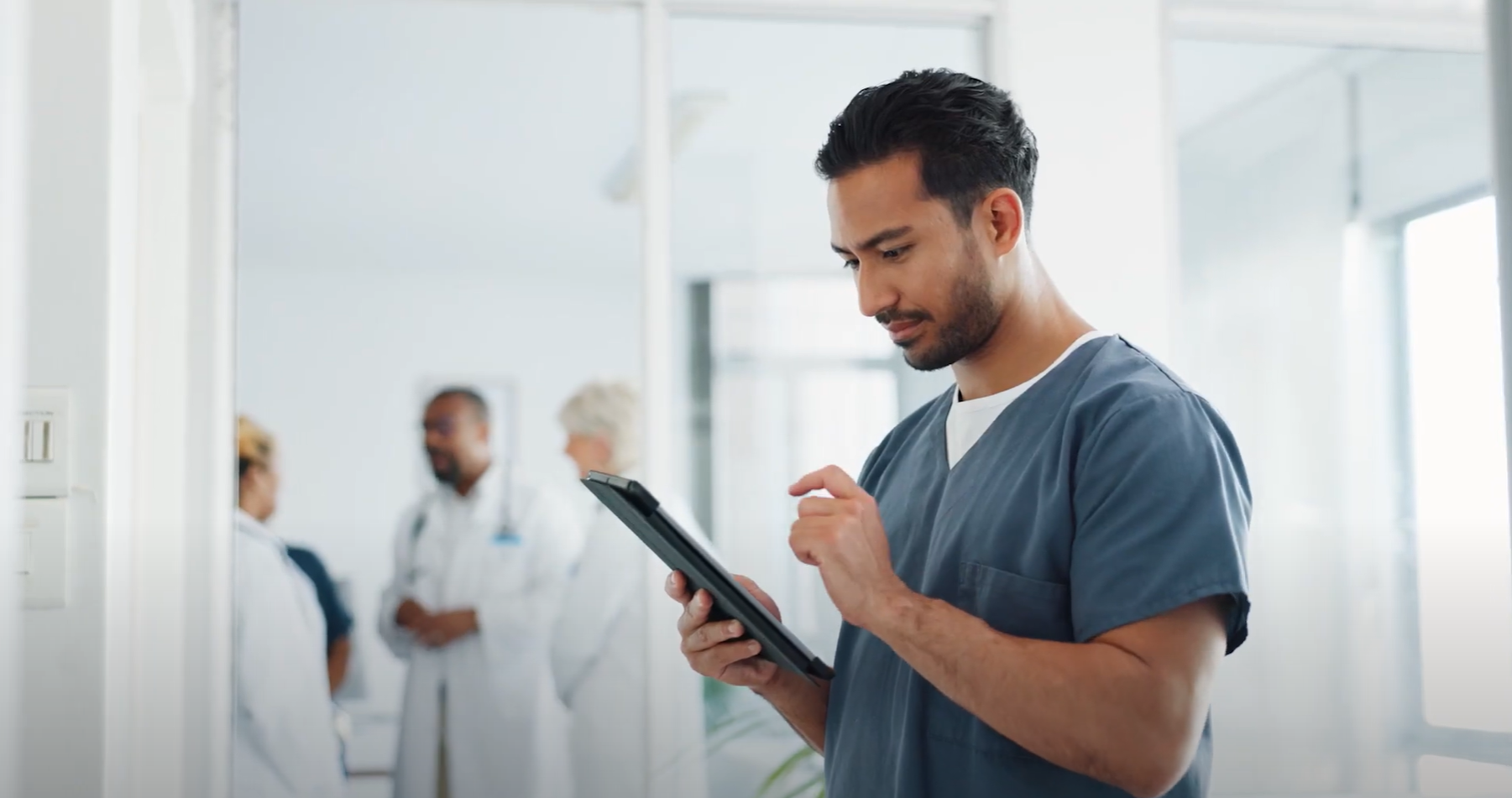 A photo of a healthcare employee working on a laptop. 