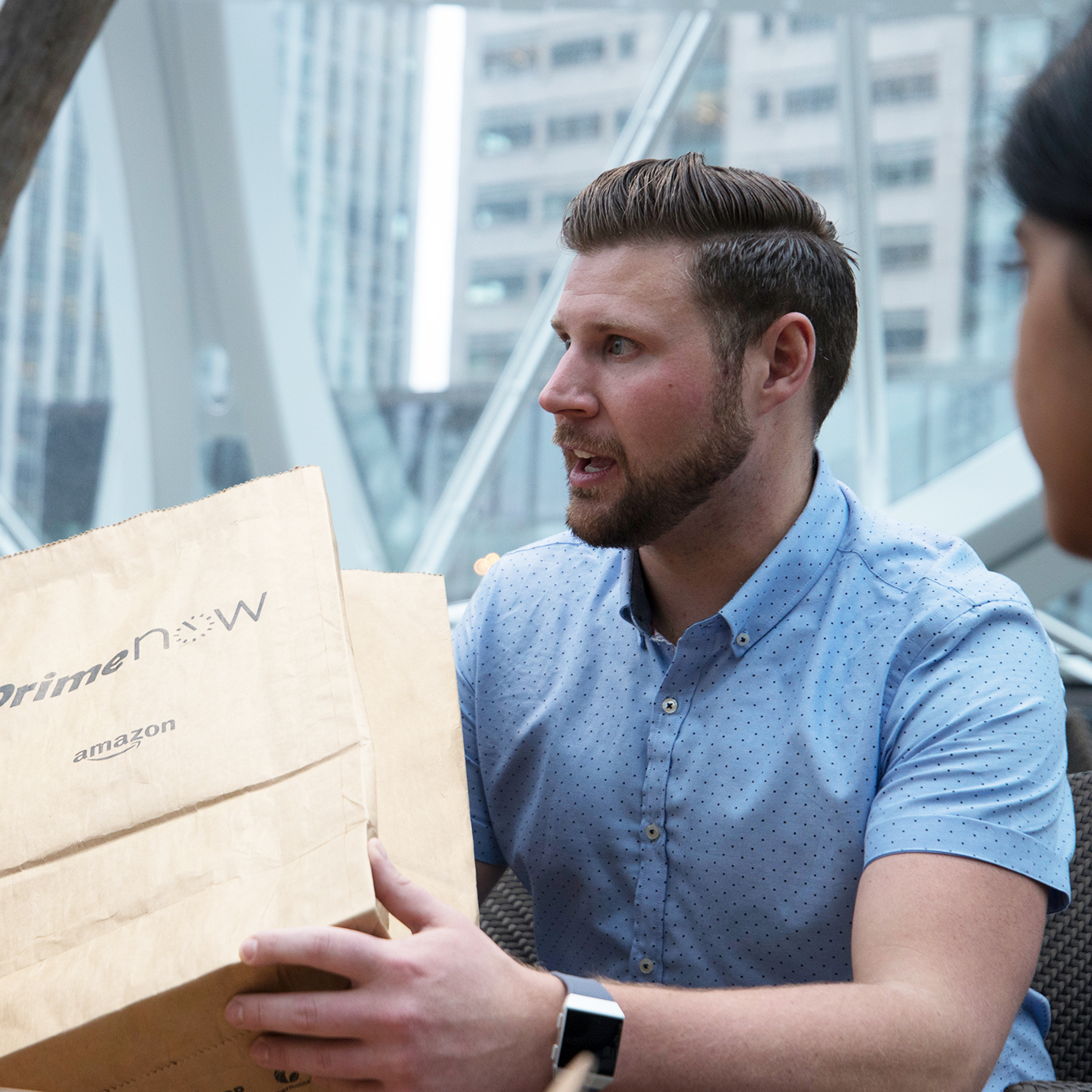 A man holds a Prime Now package.