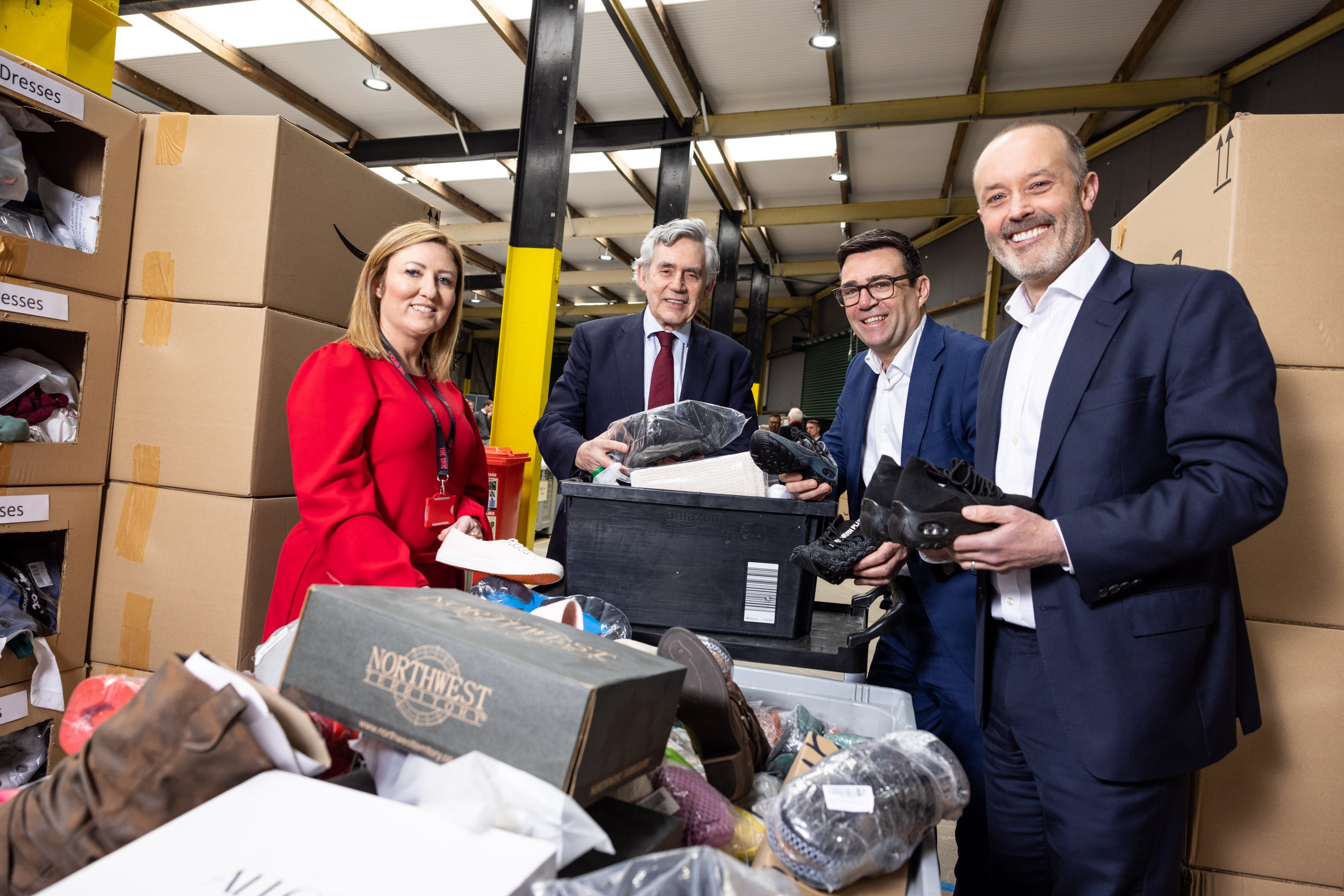 Four people, including John Boumphrey and Gordon Brown, handling donations.