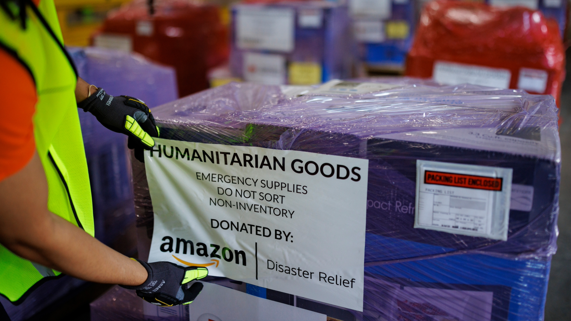 Amazon employee packaging Humanitarian Goods , emergency supplies, donated by Amazon