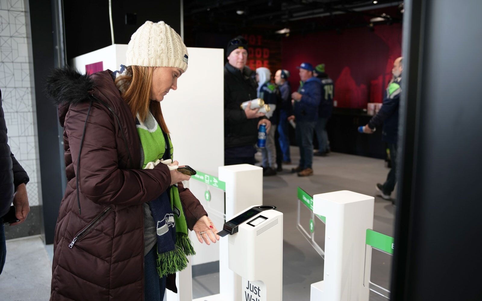 A customer inserts their credit card to enter District Market, a Just Walk Out technology store, in Lumen Field.
