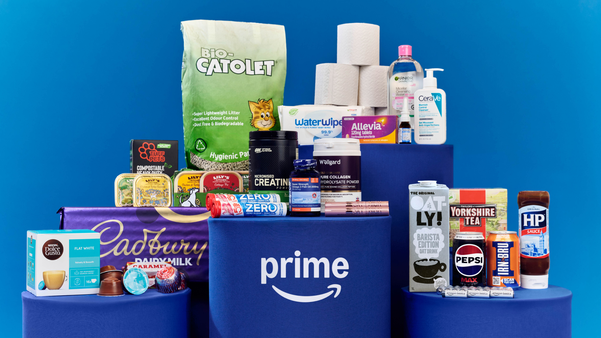 Amazon Prime delivery box surrounded by diverse household products and groceries
