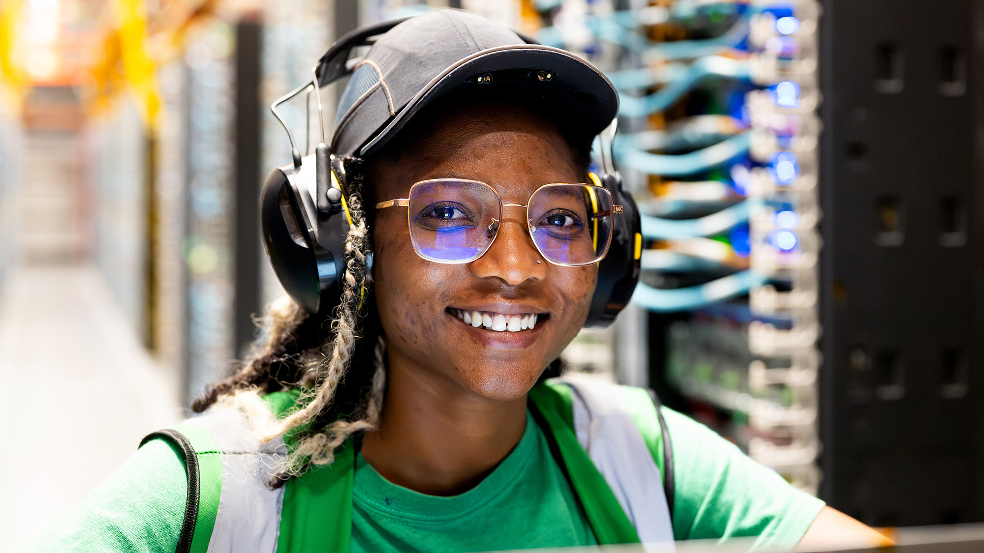 A data center technician smiling