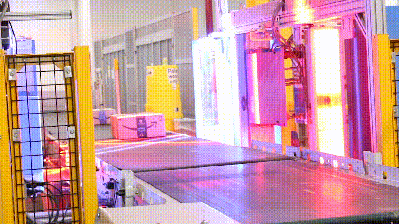 A gif of packages on a conveyor belt at an Amazon fulfillment center