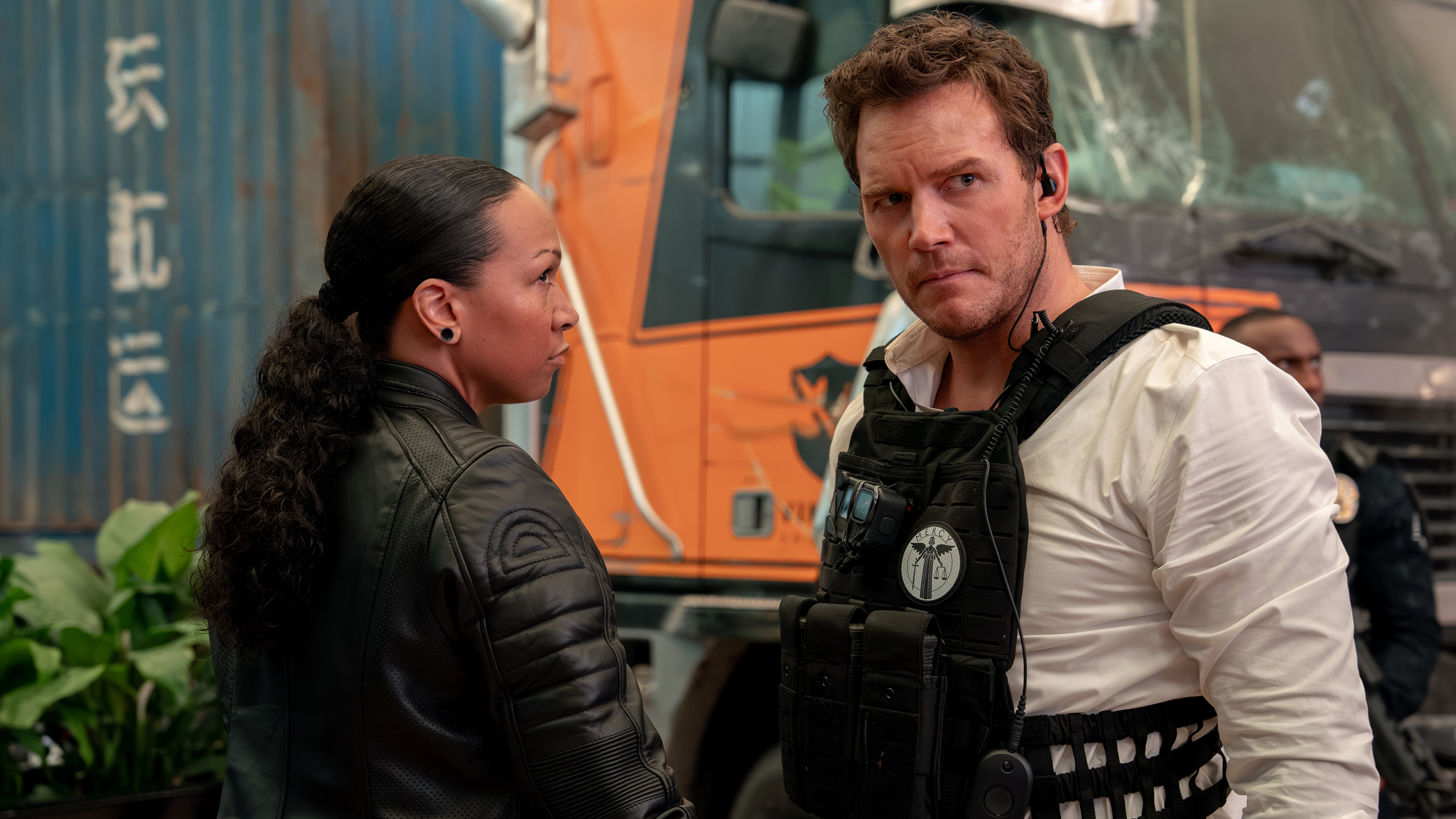 Mercy movie Serious conversation between woman in leather jacket and man wearing bulletproof vest