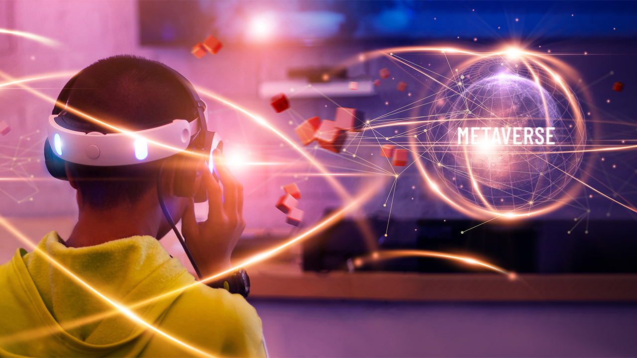 A teen gaming with a VR headset and a screen depciting metaverse