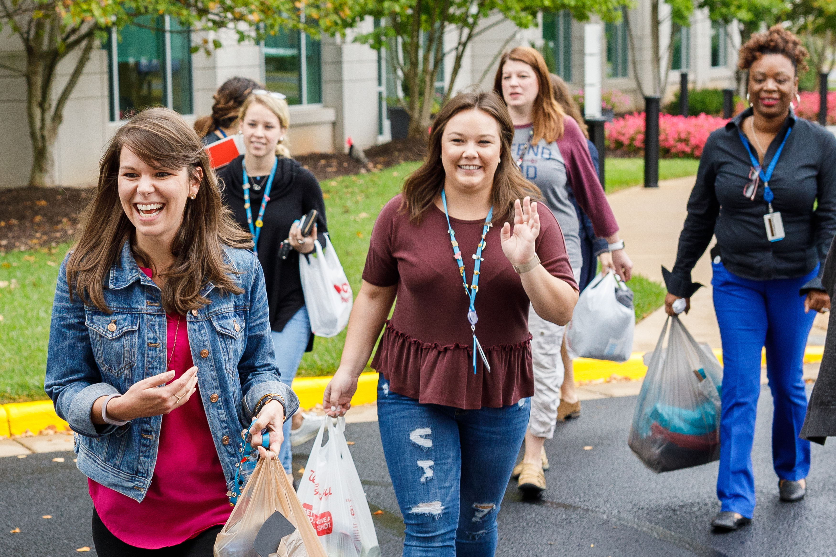 A group of smiling Amazon employees takes #DeliveringSmiles donations from Washington, D.C. - area residents to Friendship Place  in Washington, D.C.