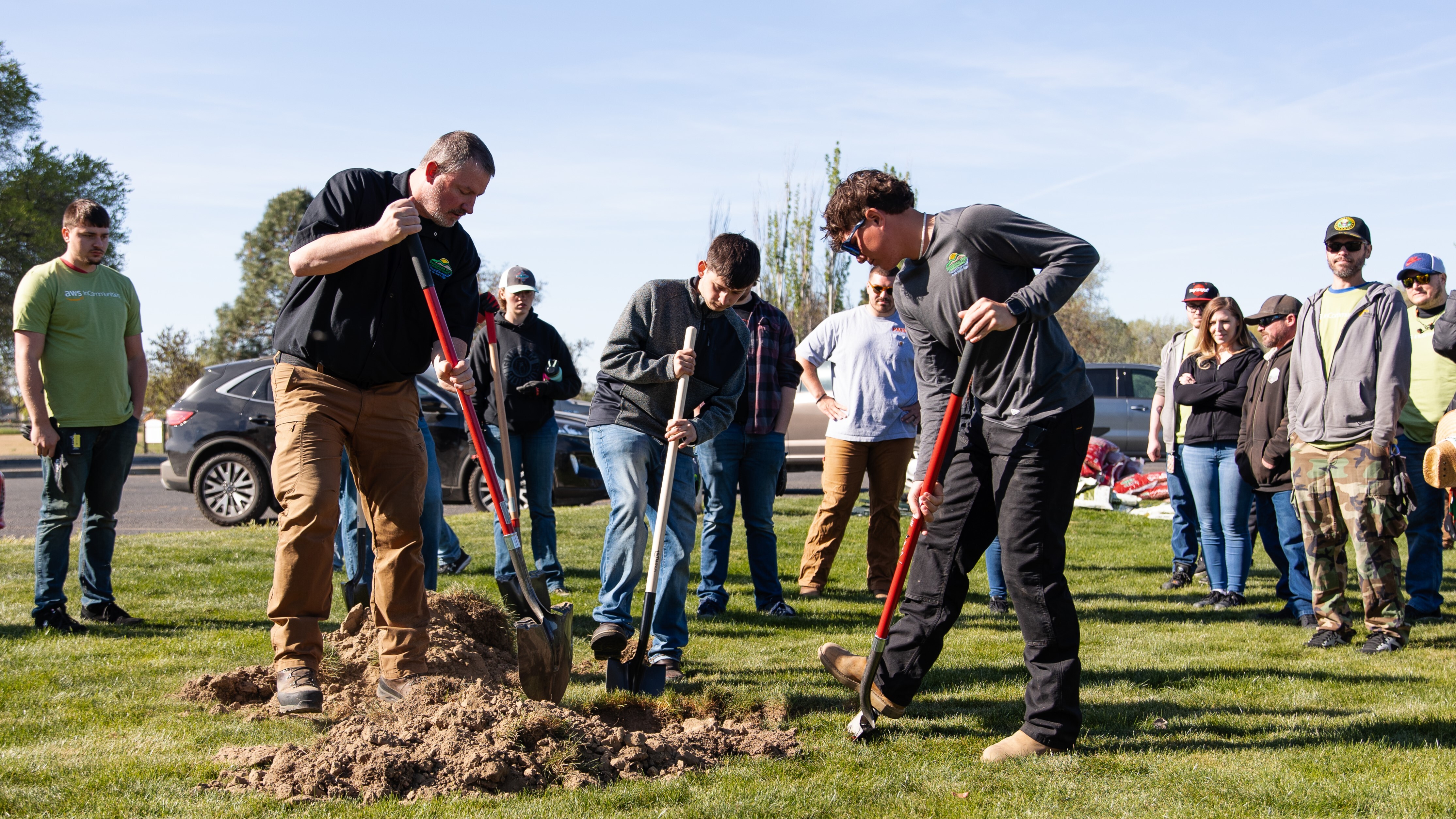 An image of a group of people digging a hole.