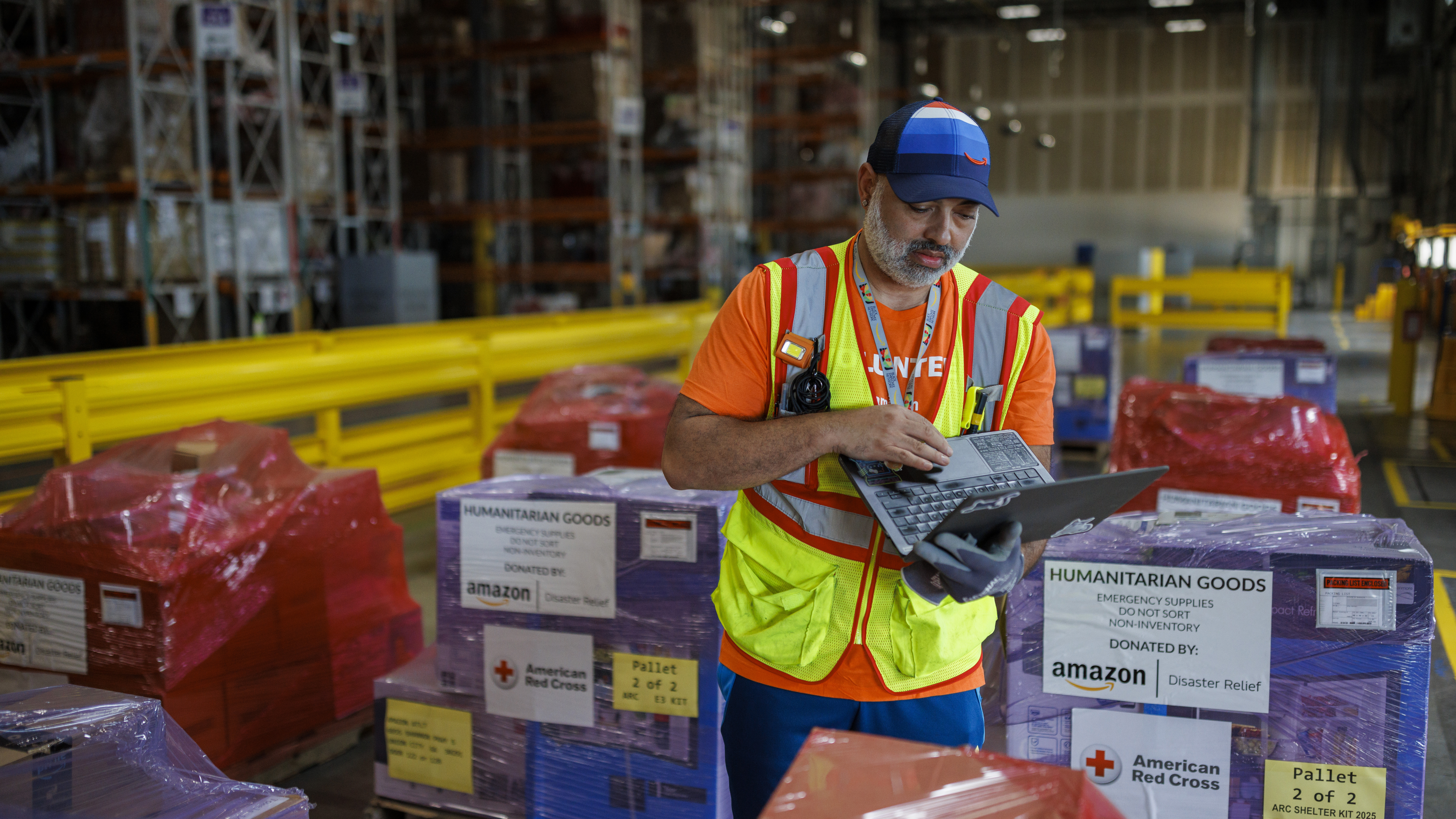 ATL7 Warehouse worker checks inventory of humanitarian aid supplies in Disaster Relief Hub in Union CityGa