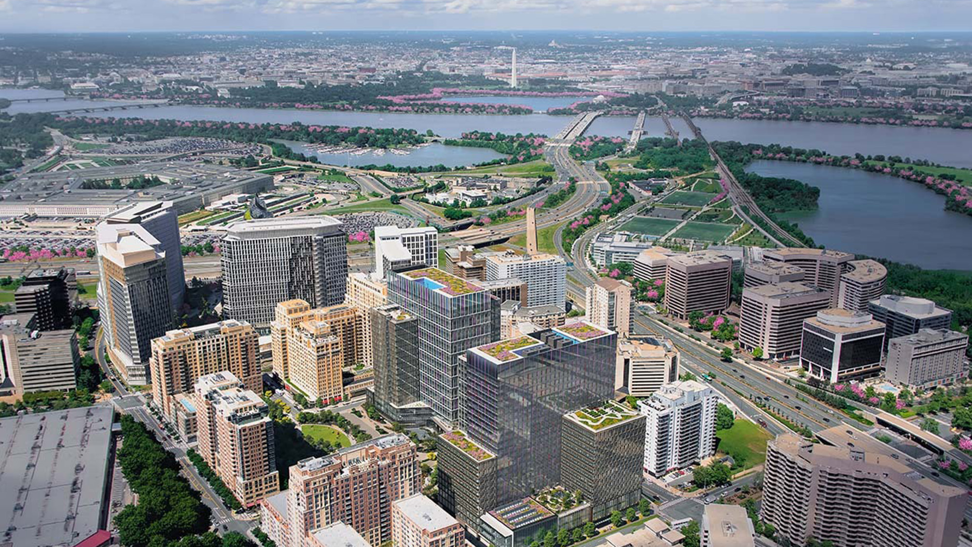 Aerial view of Amazon's HQ2 in Arlington, Virginia, with Washington D.C. in the background.
