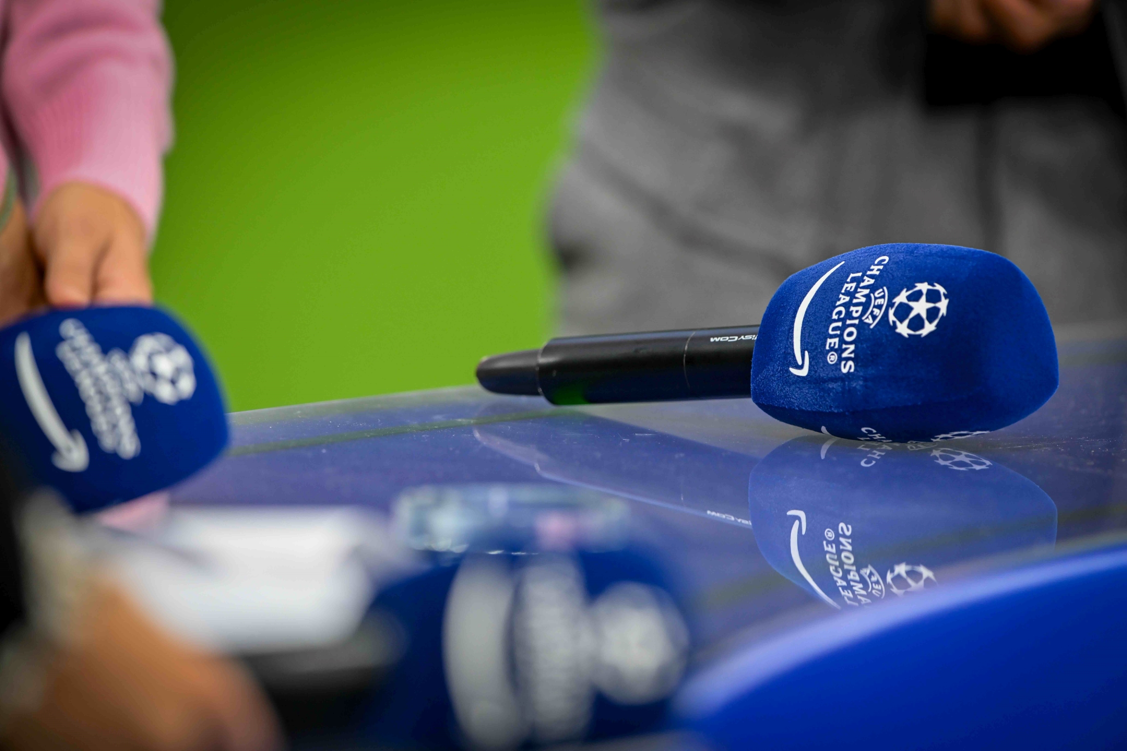 Blue UEFA Champions League microphones on reflective surface