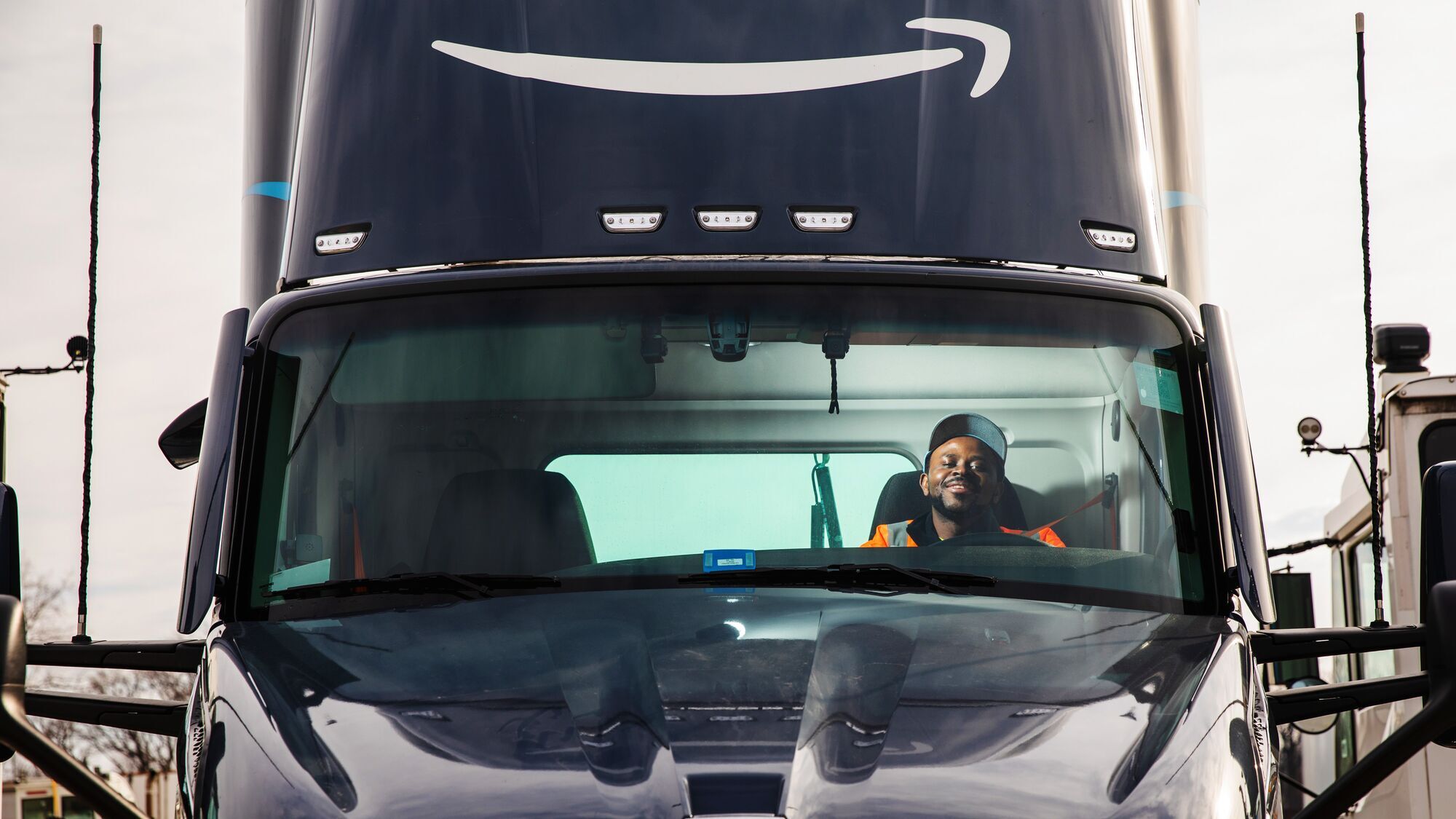 abel tuyisenge an amazon transportation associate sits in the drivers seat of an amazon truck