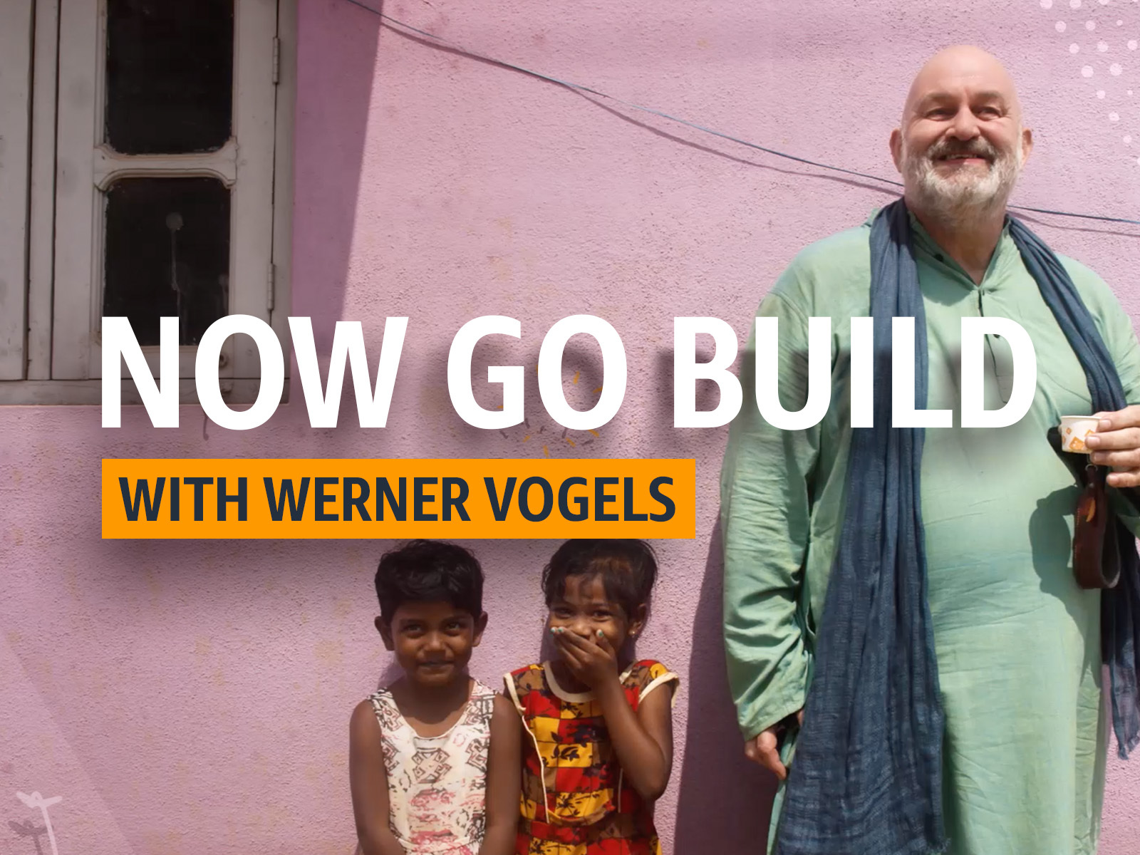 Werner Vogels, CTO of Amazon stands besides two young children in India