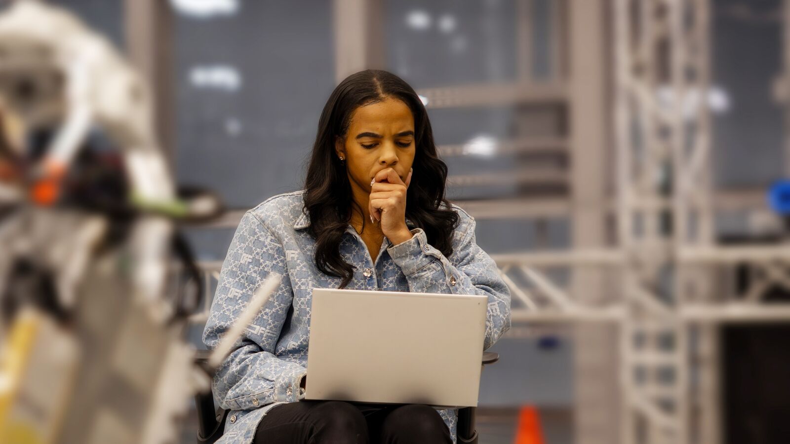 Professional deep in thought while working on laptop