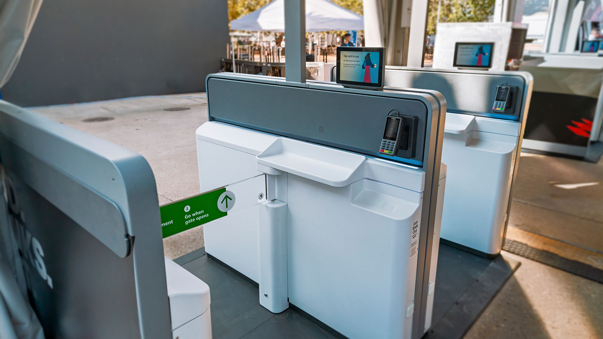 Modern airport check-in kiosk with digital displays and payment terminal