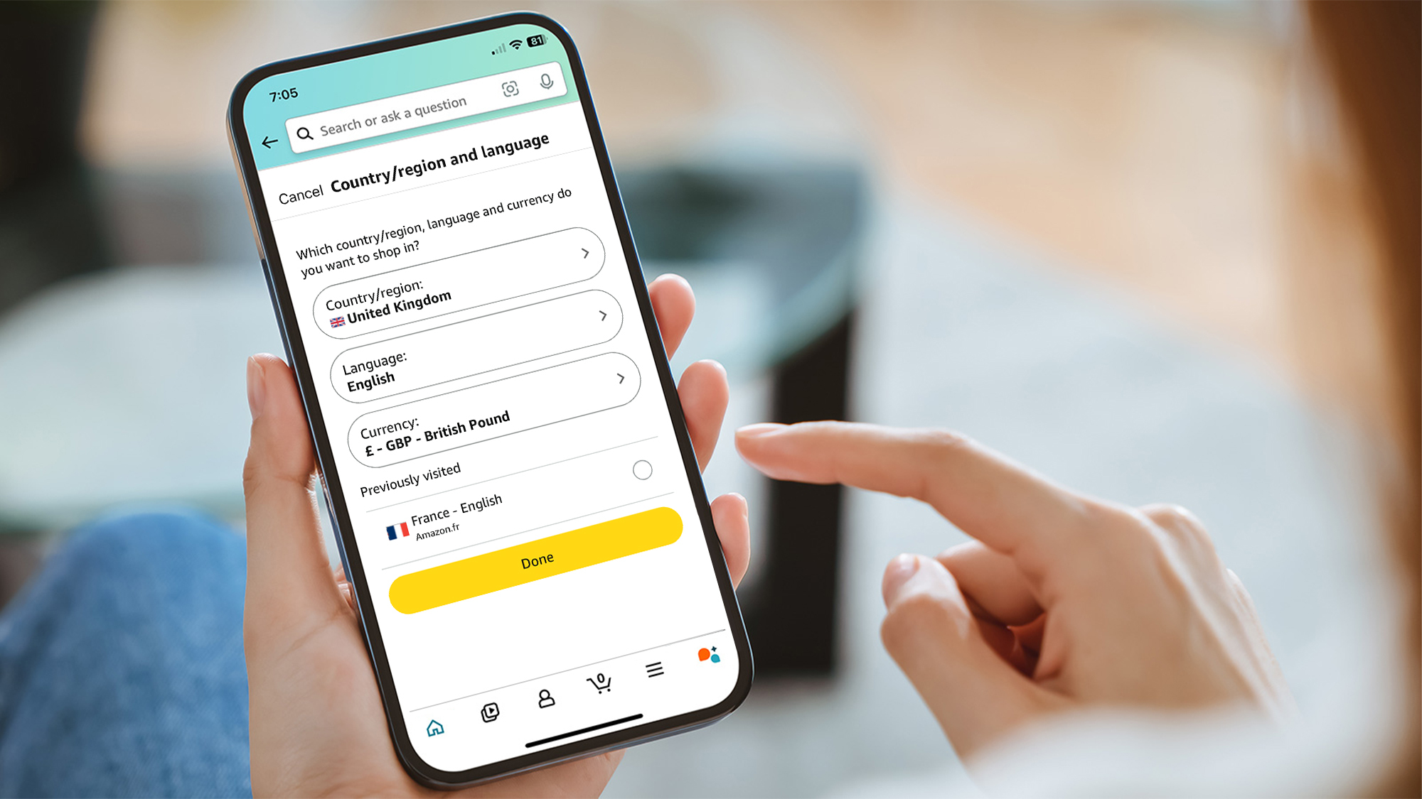 A phone showing the option to change the country and region settings in the Amazon app