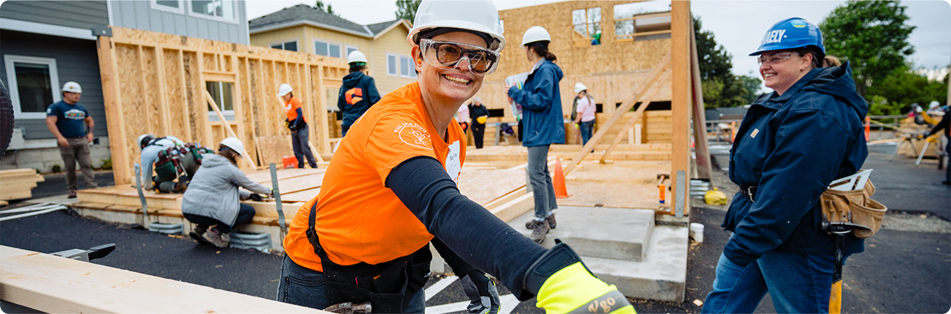 Community build project with diverse team working on wooden frame structure