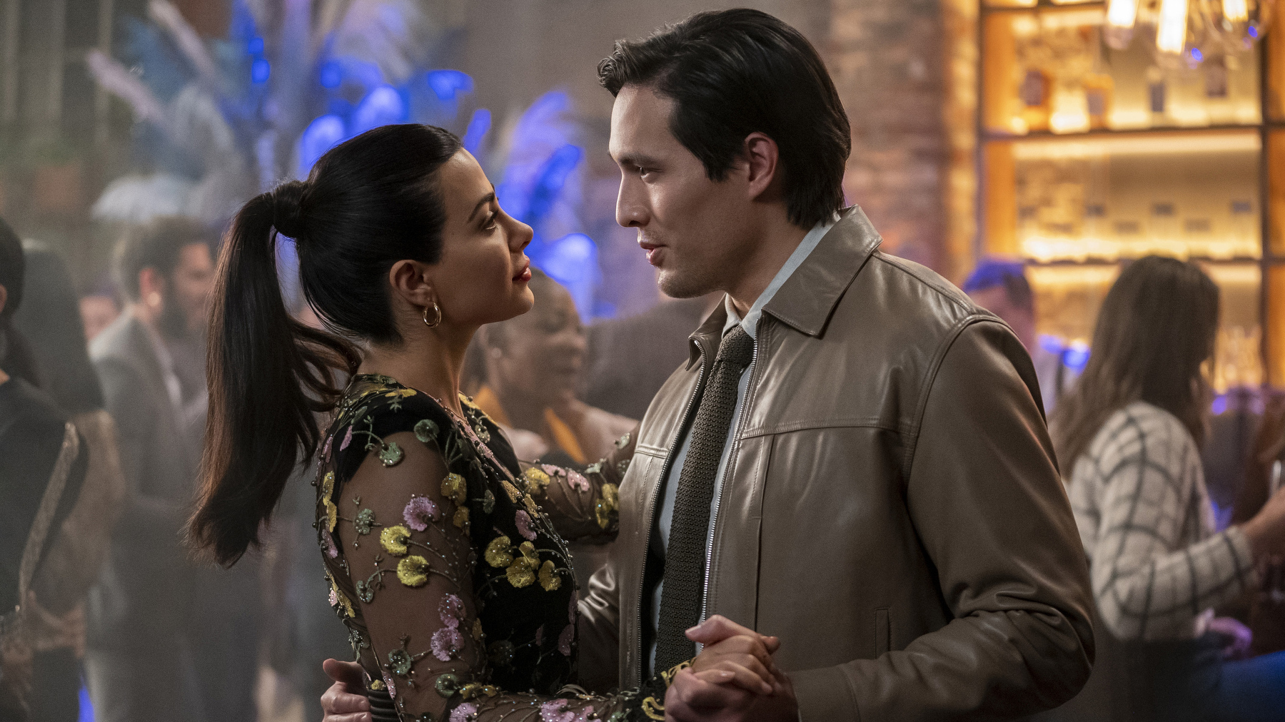 Emeraude Toubia and Desmond Chiam are pictured here dancing in a bar while talking. They star as Lily Diaz and Nick Zhao in the new Prime Video show 'With Love.'