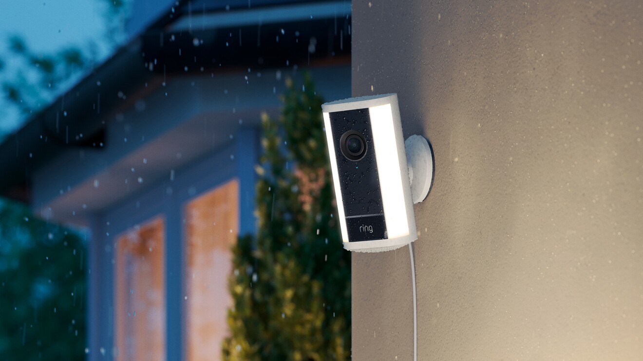 Ring doorbell camera illuminated at night during light rain