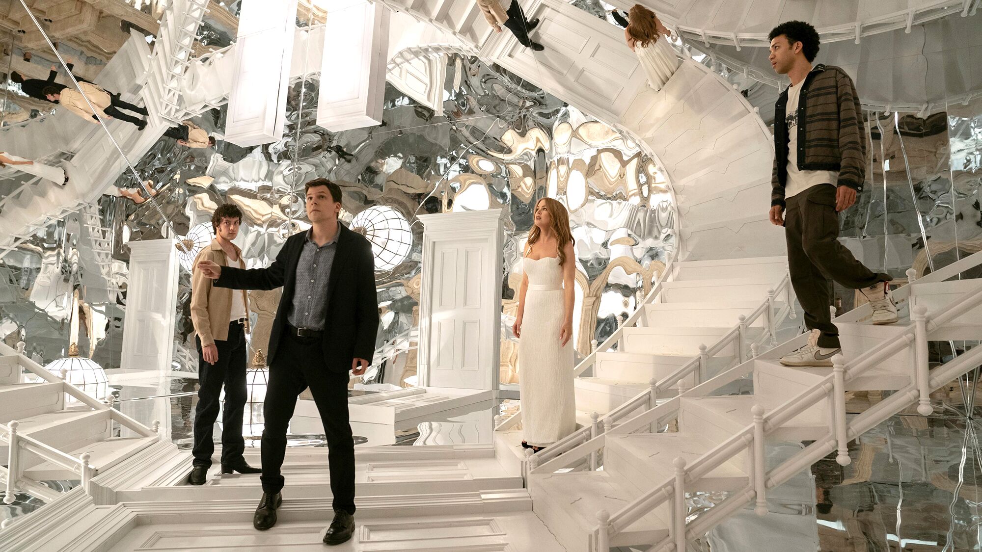  'Now You See Me' movies: Futuristic white set with mirrored walls, stairs, and five people in stylish outfits
