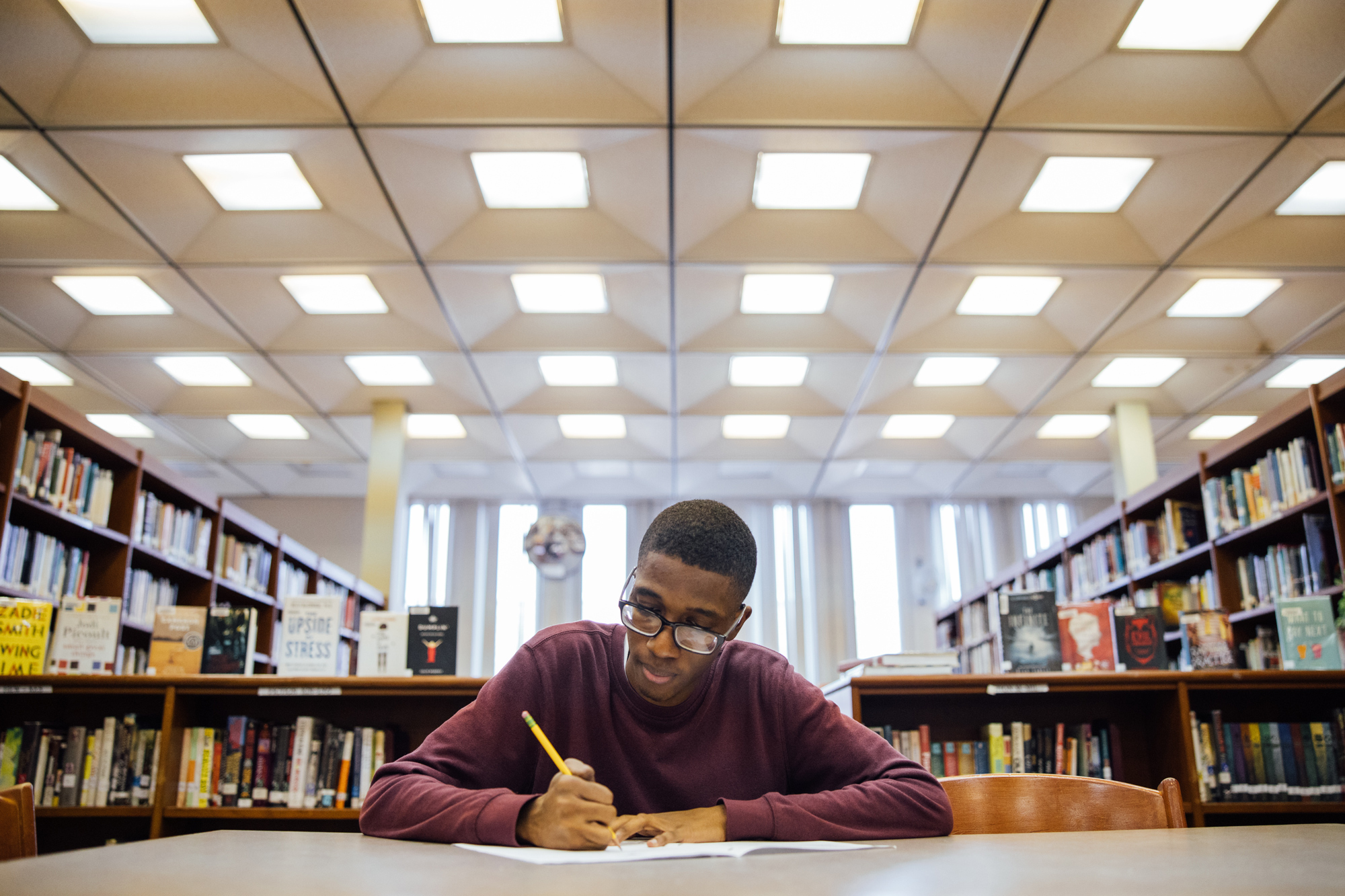 Amazon Future Engineer student studying at a desk in the library.