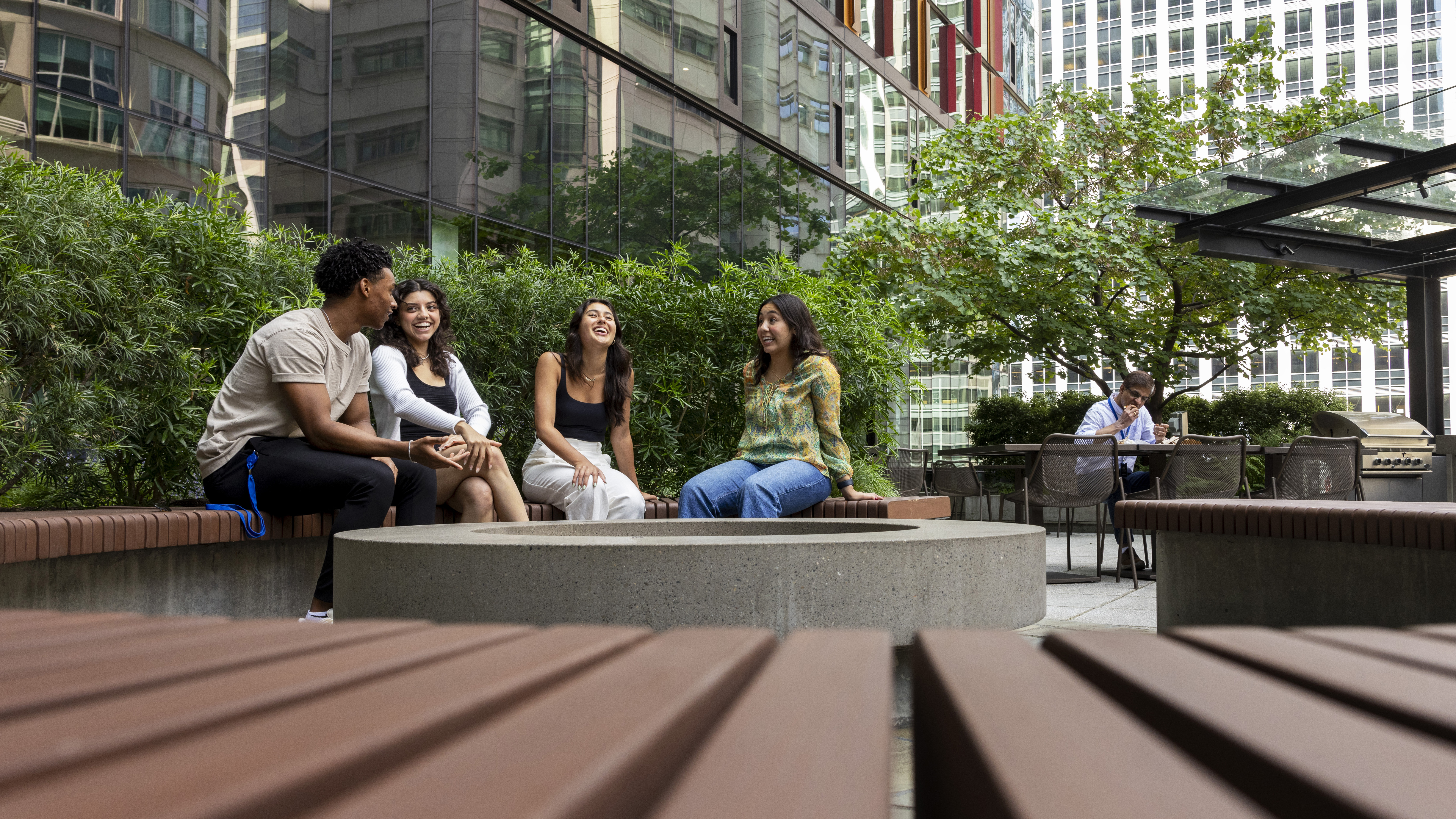 Four employees laugh outside on Doppler's terrace.