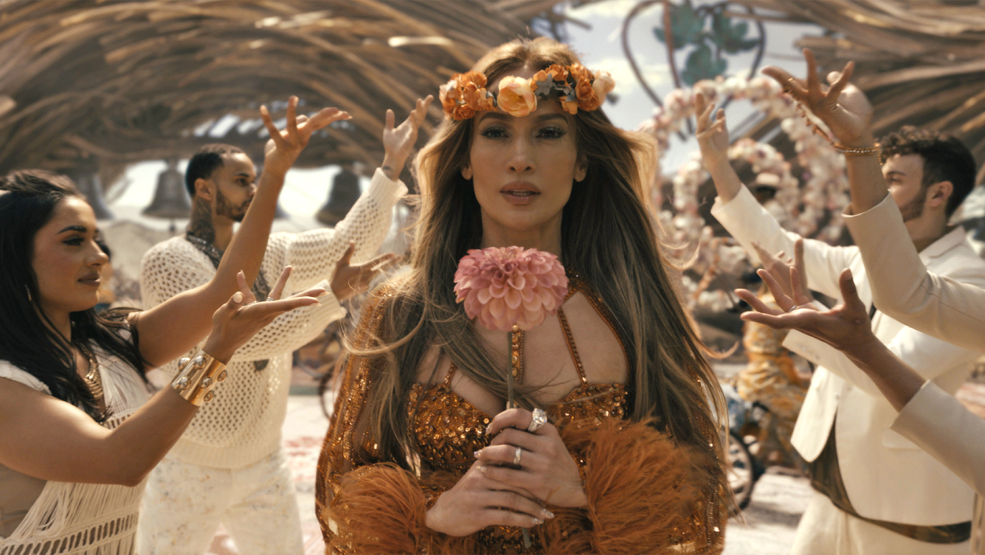 A woman holding a bouquet walking down the aisle on a beach
