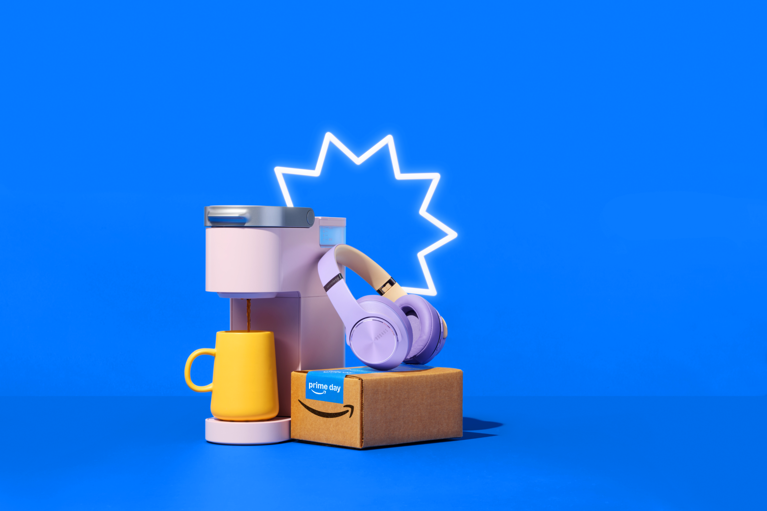 A coffee maker, headphones, and Amazon Prime box on a blue background with a neon star